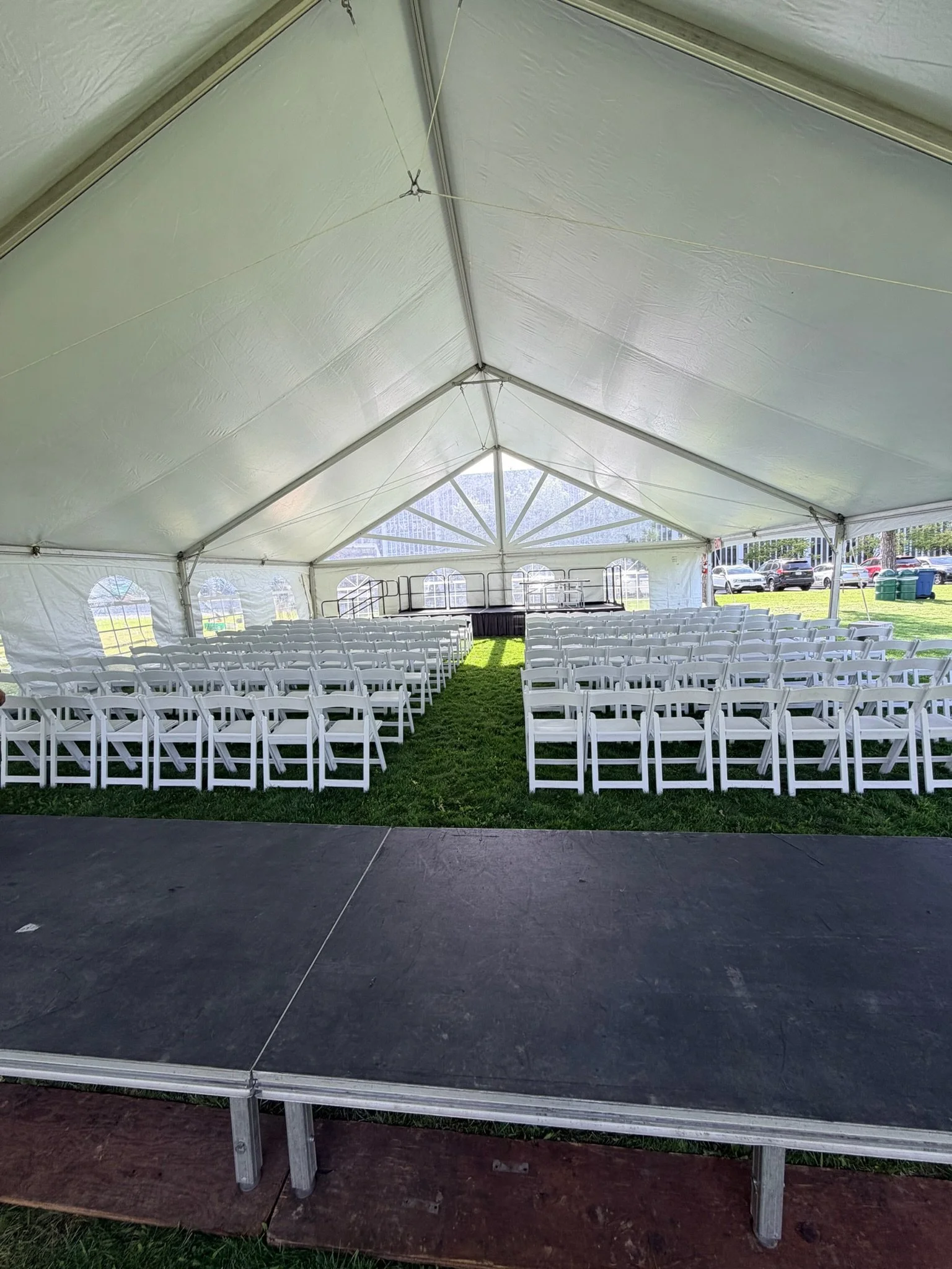 Stage and chair setup under 40' frame tent at SUNY Albany. Setup by Whalen Tents