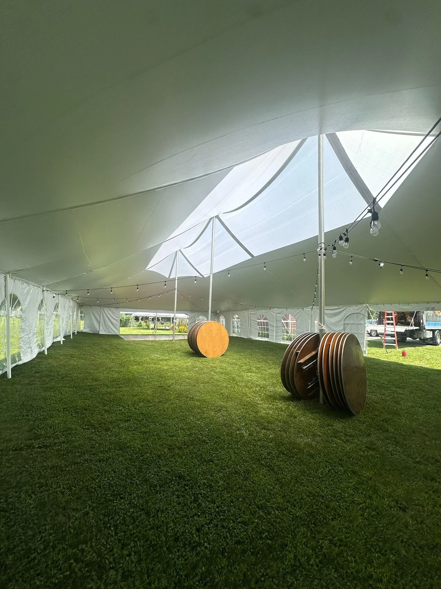 Skylight Tent  setup for a wedding with Edison lights. Setup by Whalen Tents