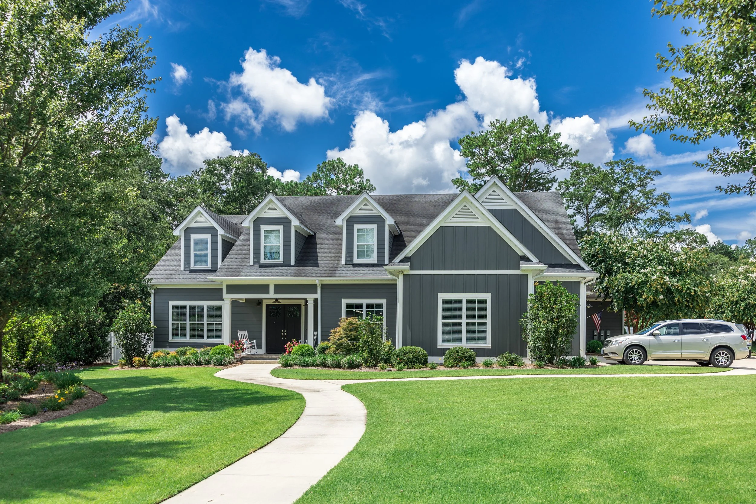 A well-maintained front yard with lawn mowing, plantings, and landscape design in West Greenwich, RI.jpg