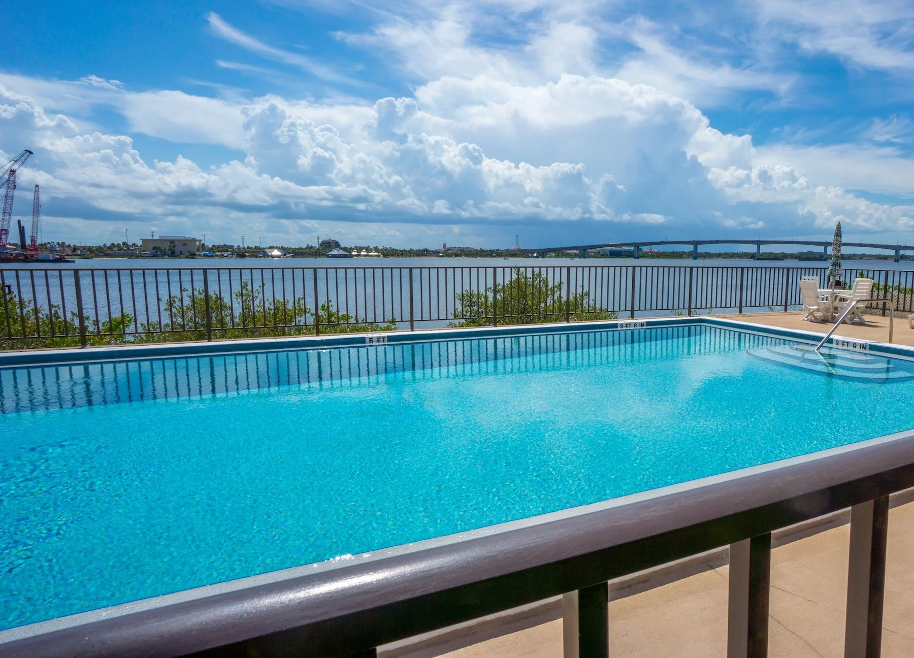 A fenced in pool located near river GrandScapes