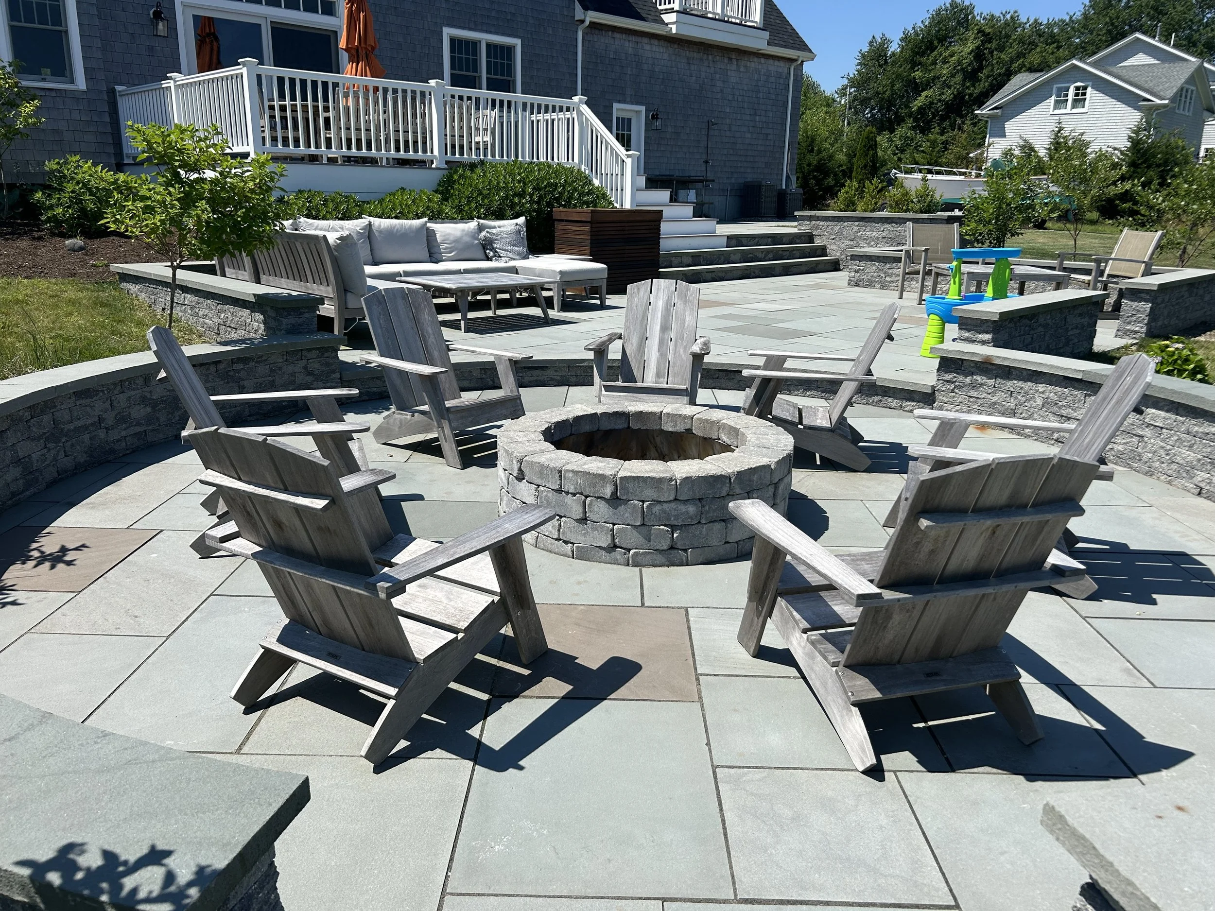 Stone patio and fire pit by GrandScapes