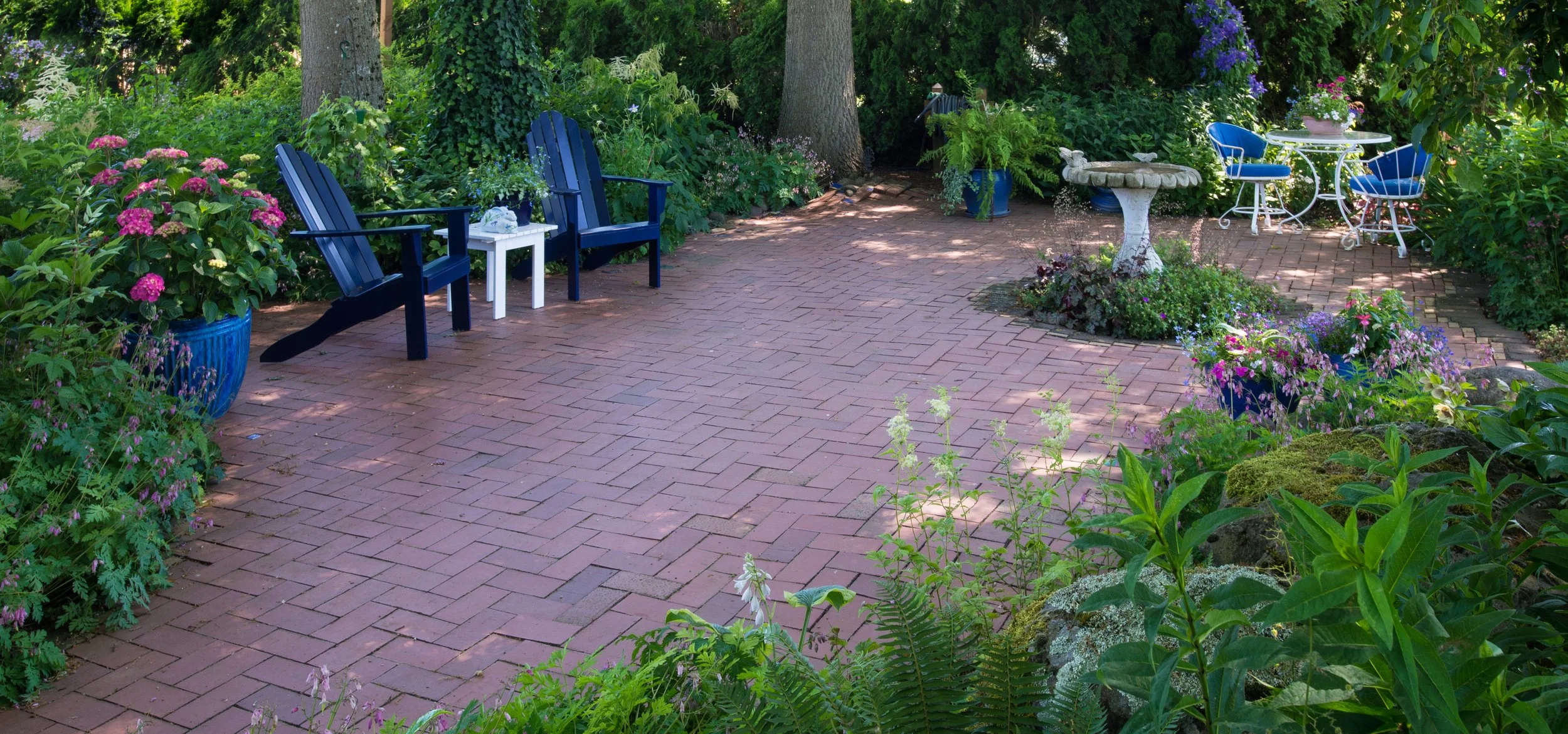 A backyard featuring paver patio, plantings, and landscape design in Newport, RI