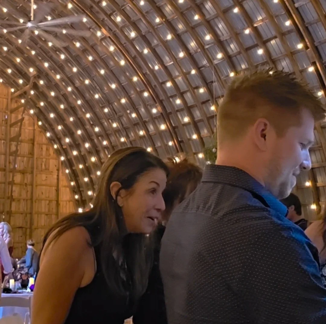 Wedding guest reacts to live wedding painting in progress.