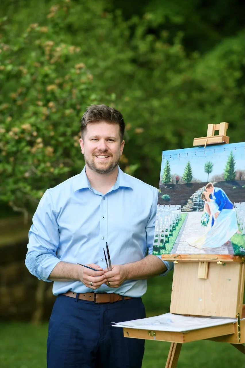 Live wedding painter smiling while painting live
