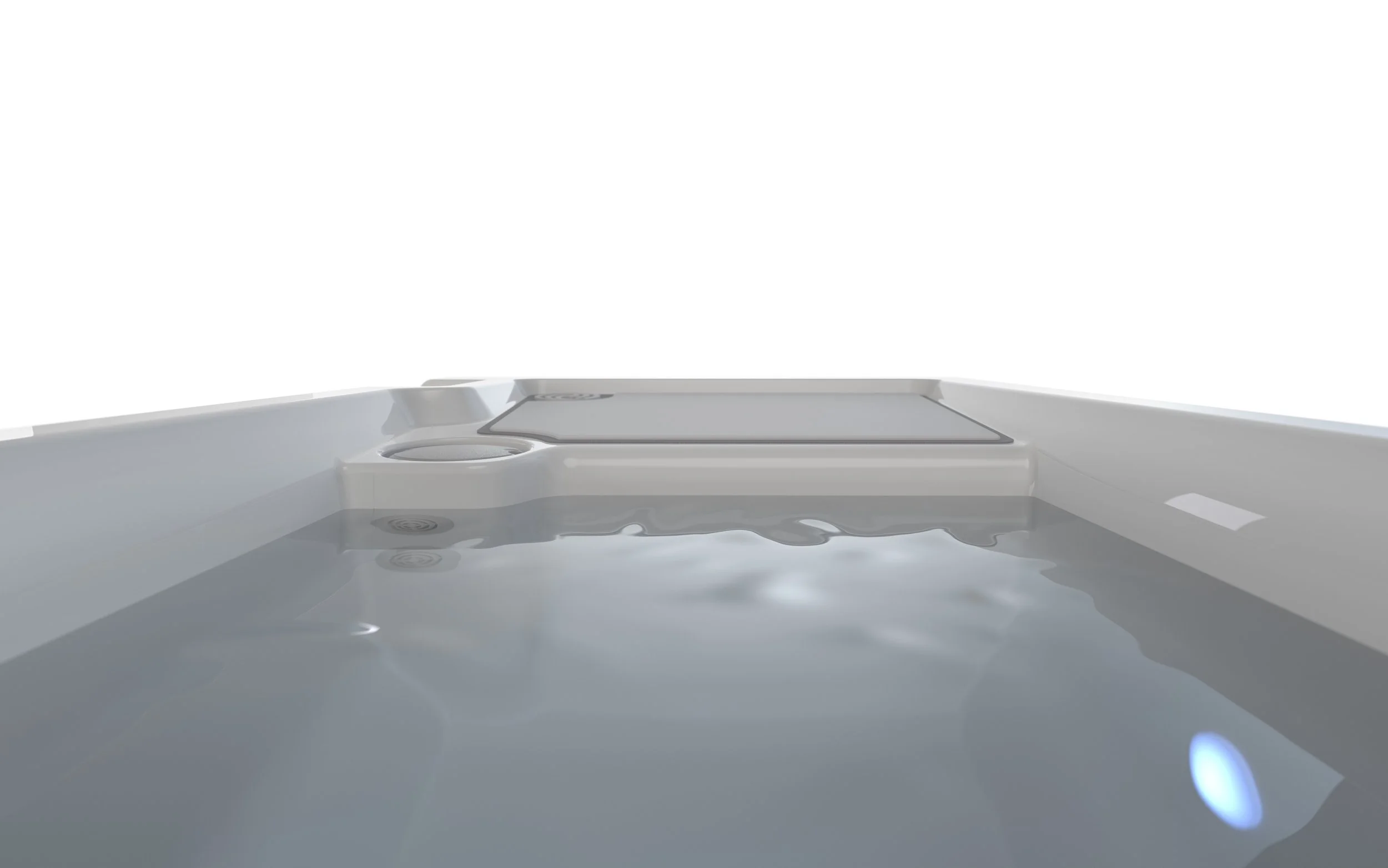 Close-up of a modern cold plunge with water, showing the built-in controls and seating area, against a plain white background.