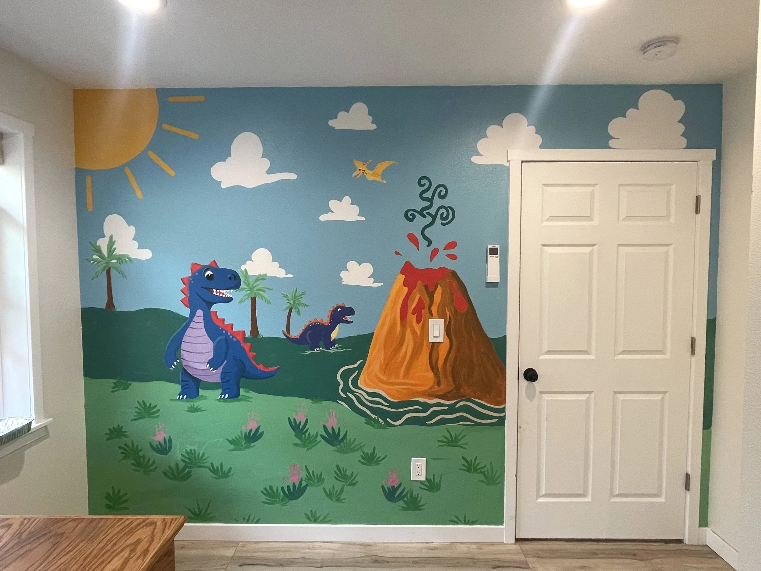 Colorful jungle scene mural with a volcano erupting, two dinosaurs, palm trees, clouds, sun, and a flying bird.