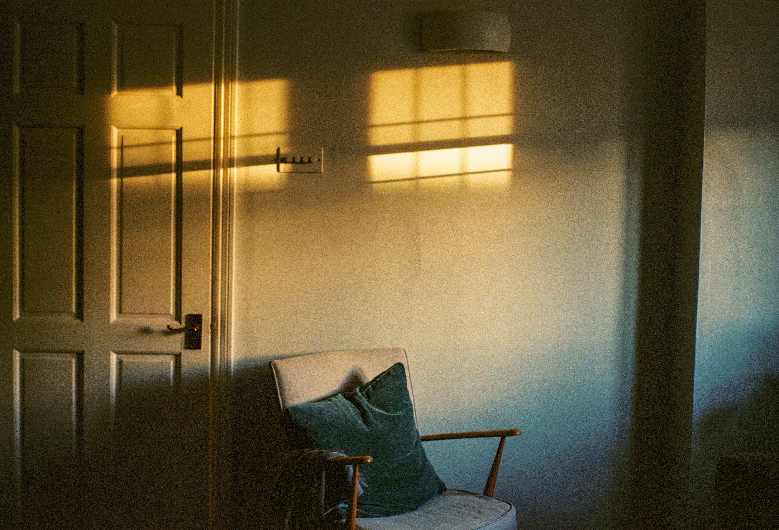 A chair in a therapy office washed in sunlight and shadows