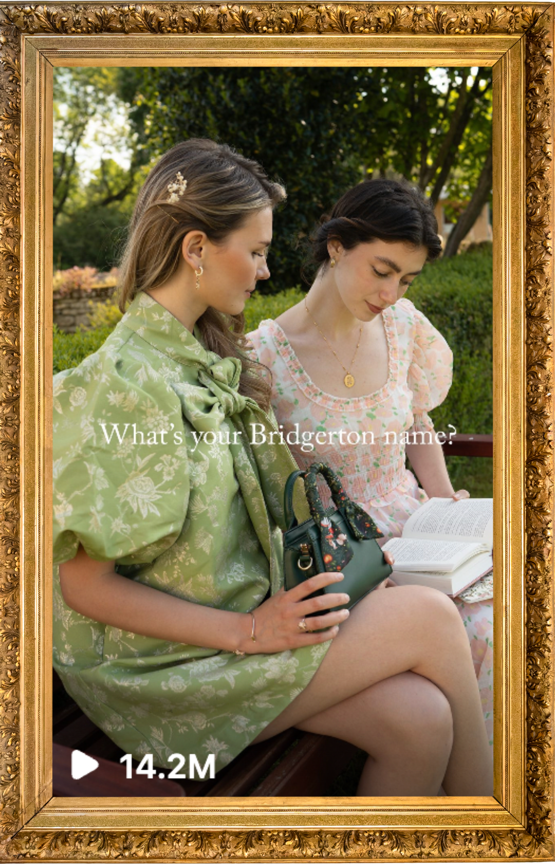 Two women sitting on a park bench reading a book, dressed in floral dresses, with green trees and bushes in the background, framed by a gold ornate frame, with text "What's your Bridgerton name?" and a play button with 14.2 million views.