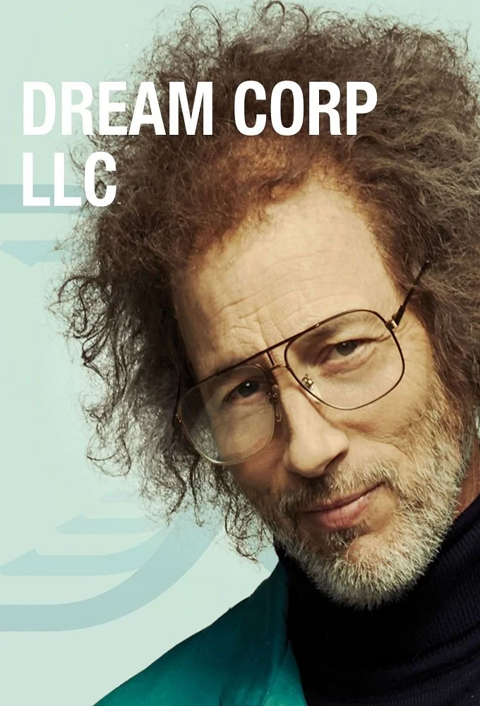 Close-up of a man with curly, gray hair, wearing glasses and a dark shirt, against a light background with the text "DREAM CORP LLC".