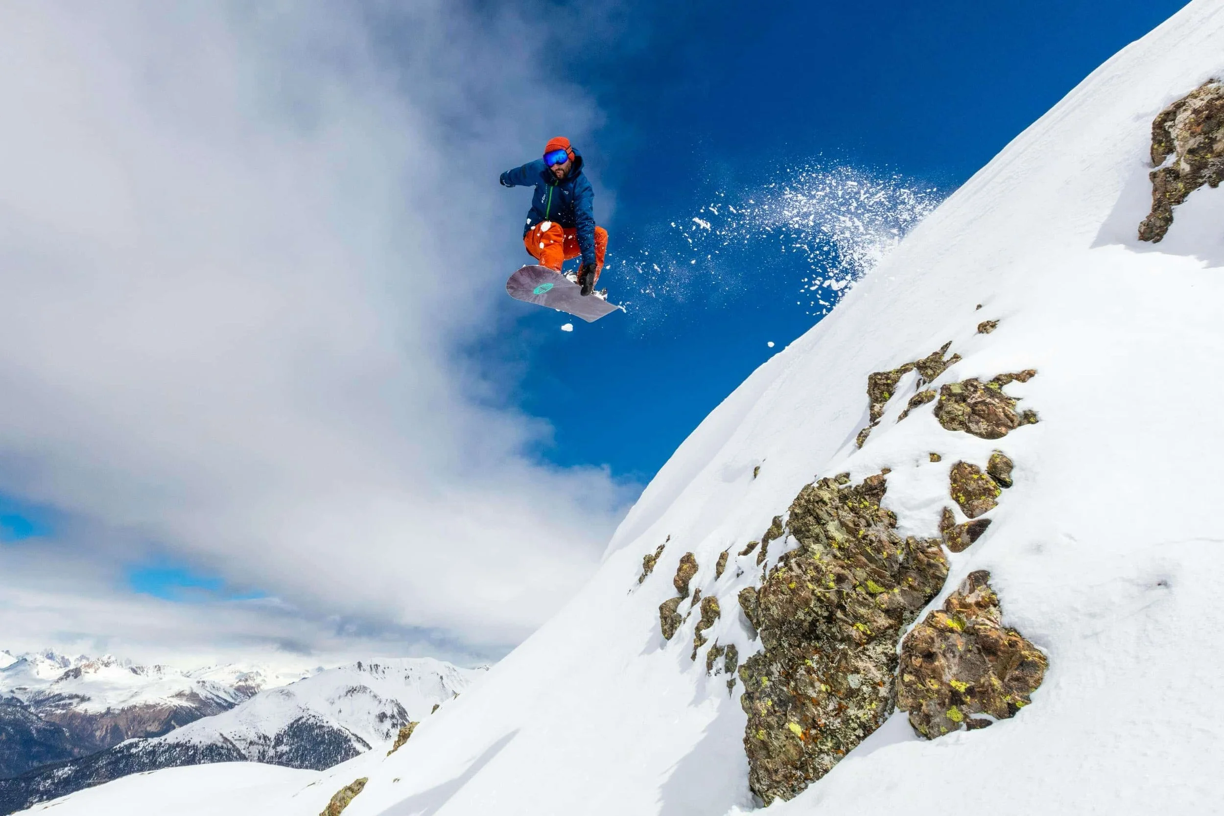 Enthusiast snowboarder jumping and catching air