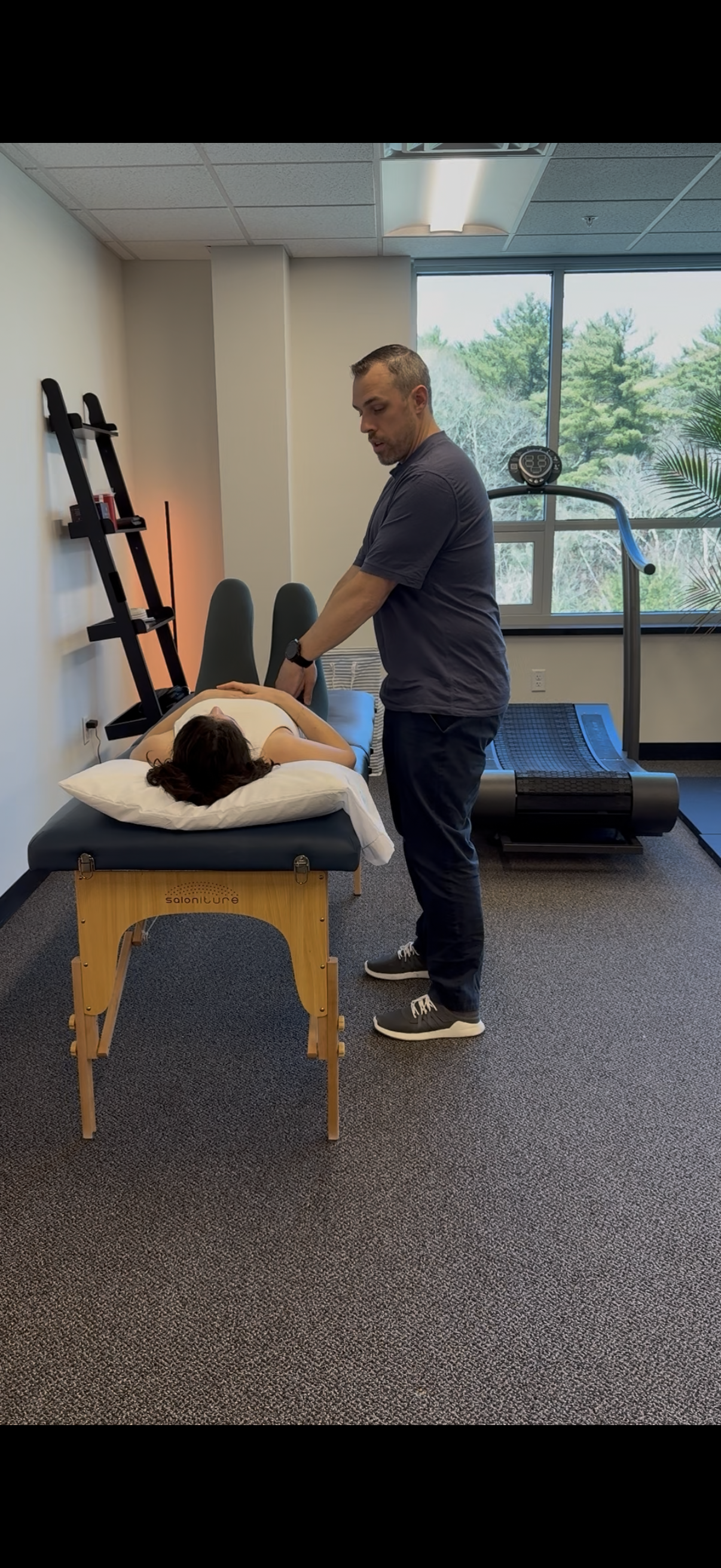 Physical therapist performing manual therapy for pain relief and posture improvement