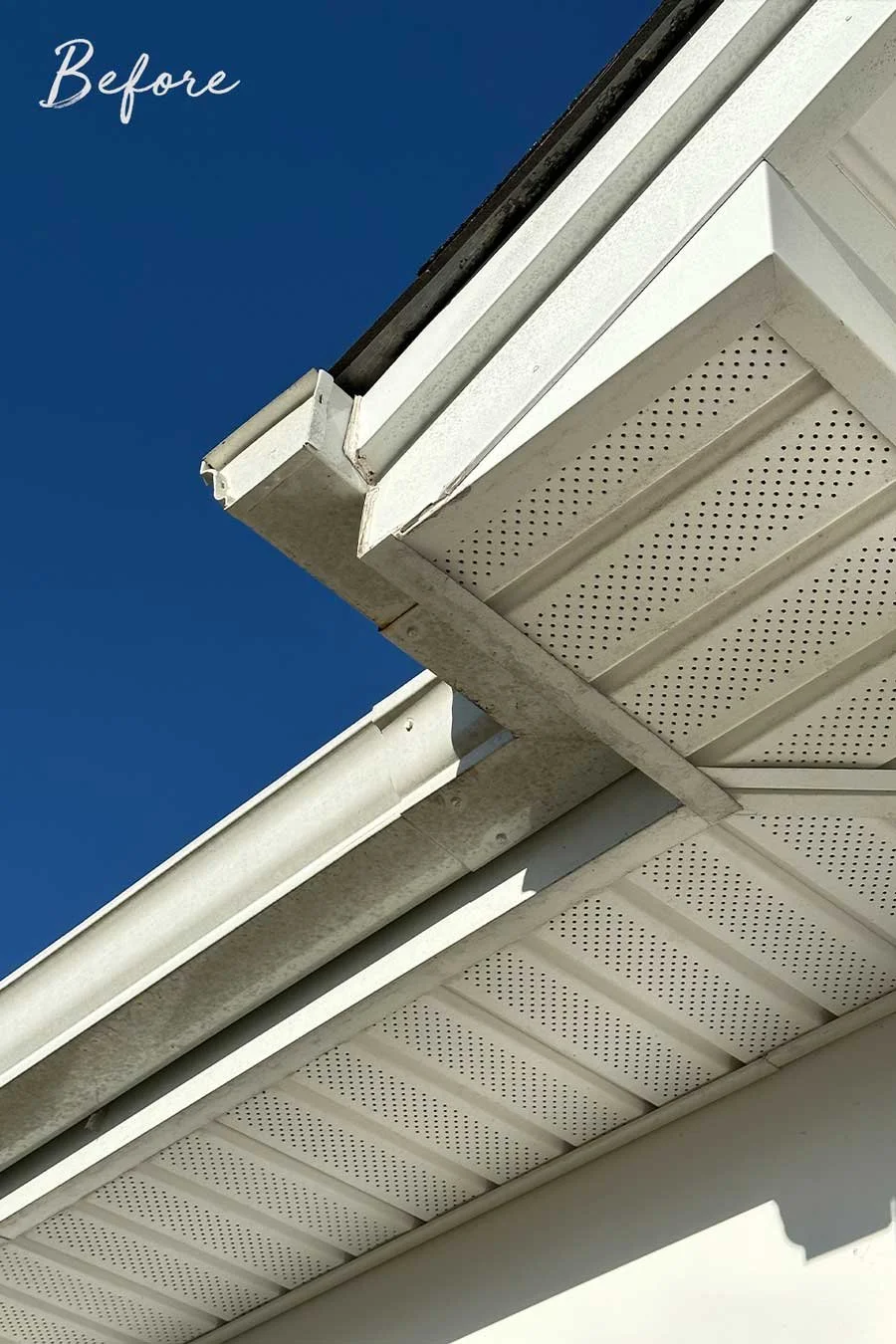 Before image of gutter and soffet with black streaks and dirt