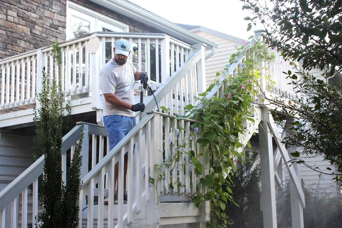 Two story wood deck being pressure washed in Waxhaw, North Carolina.
