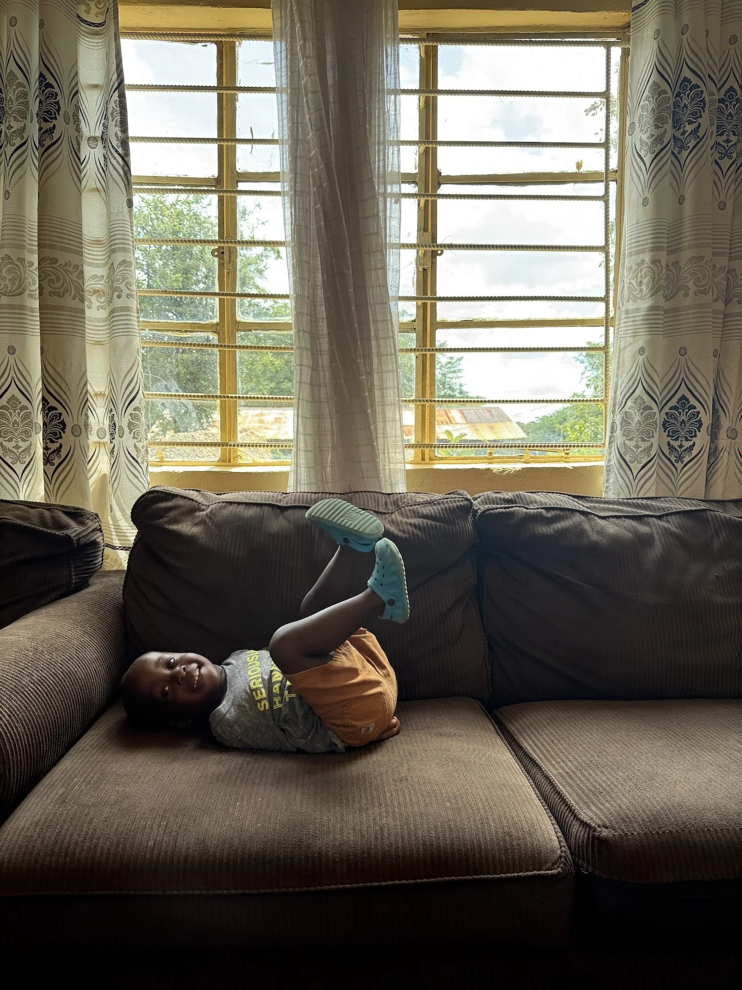 Young boy on couch at Lusungu Children's Home.