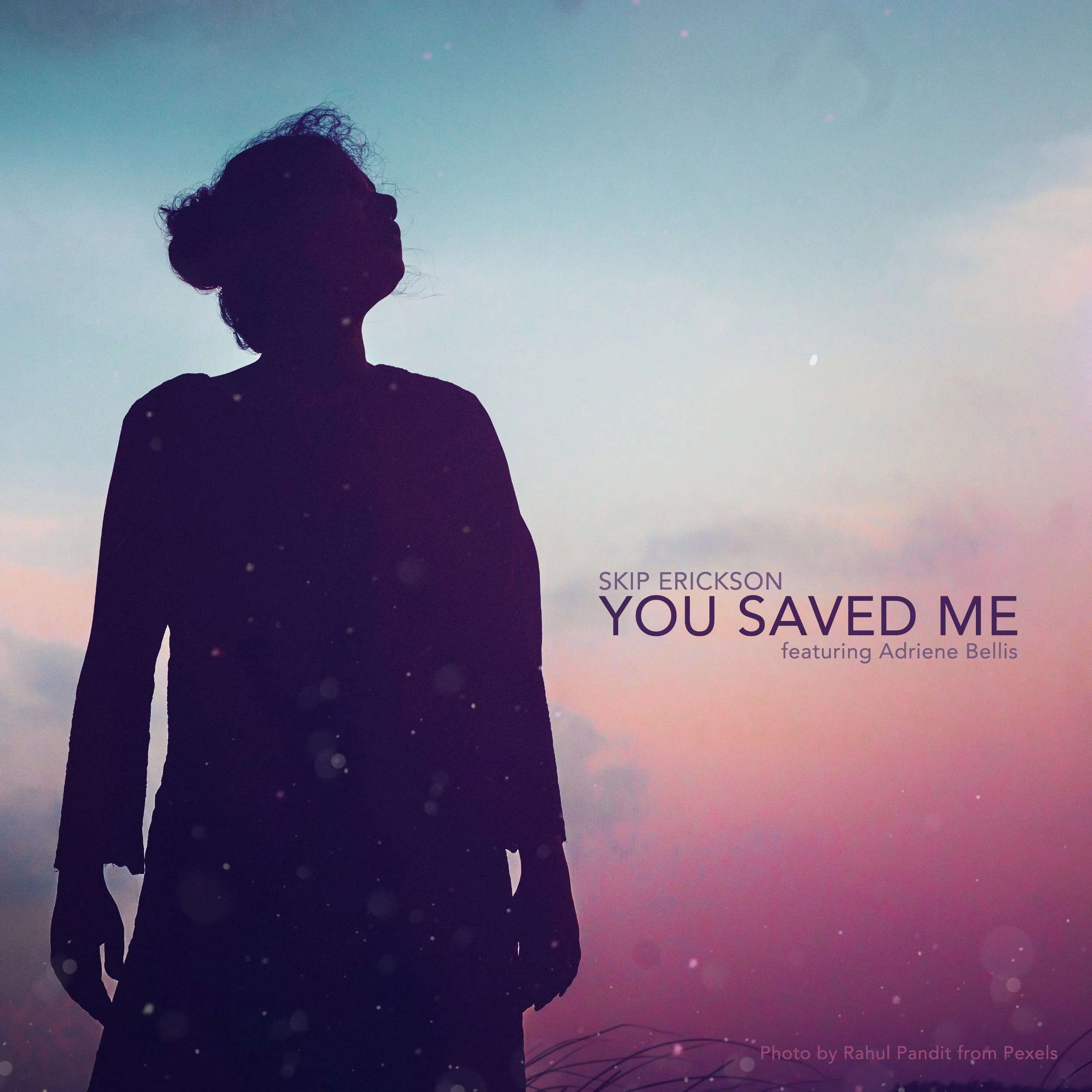 Silhouette of a woman standing outdoors during sunset or sunrise with colorful sky, and text overlay of song title 'You Saved Me' by Skip Erickson featuring Adriene Bellis, and at the bottom, 'photo by Rahul Pandit'.