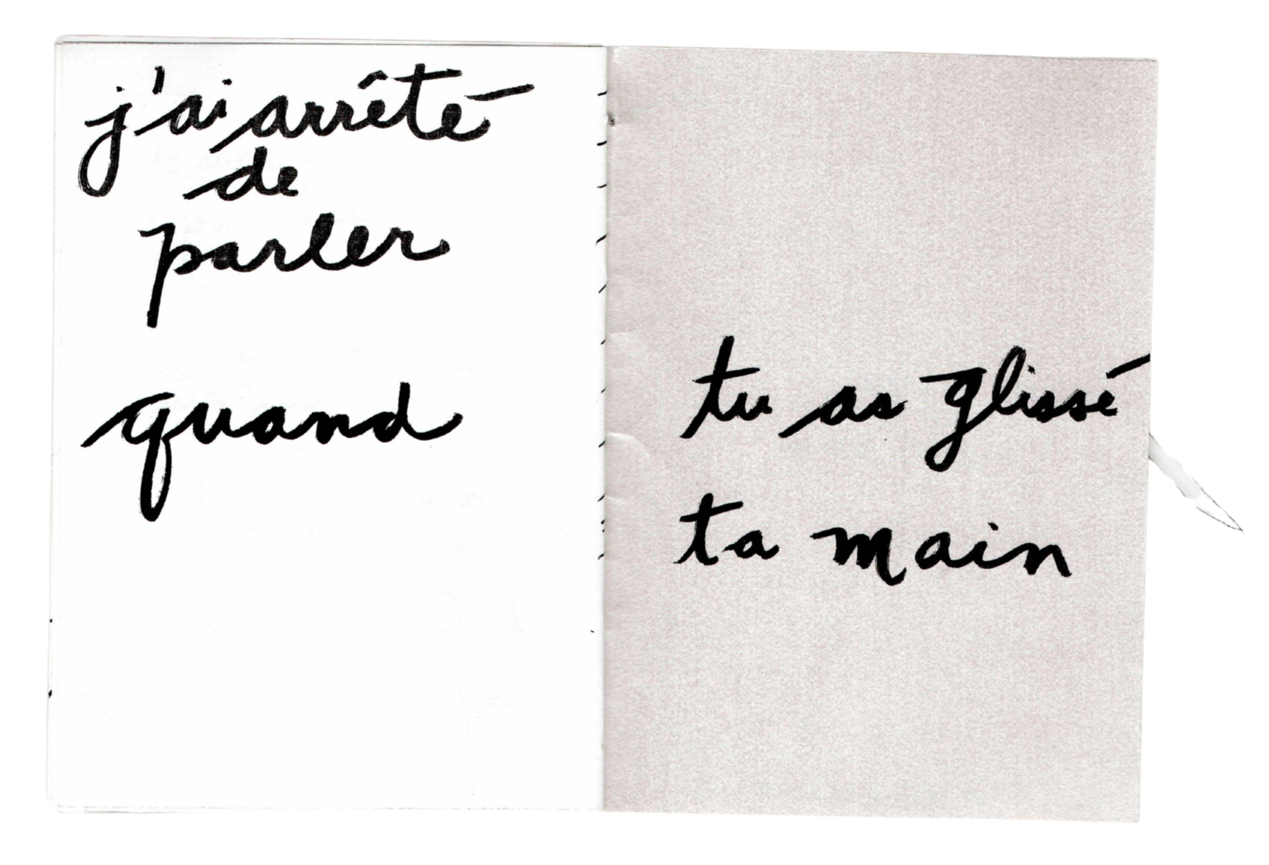 Une photo d'un carnet avec une note écrite à la main en français disant 'j'ai arrêté de parler quand tu as glissé ta main'.