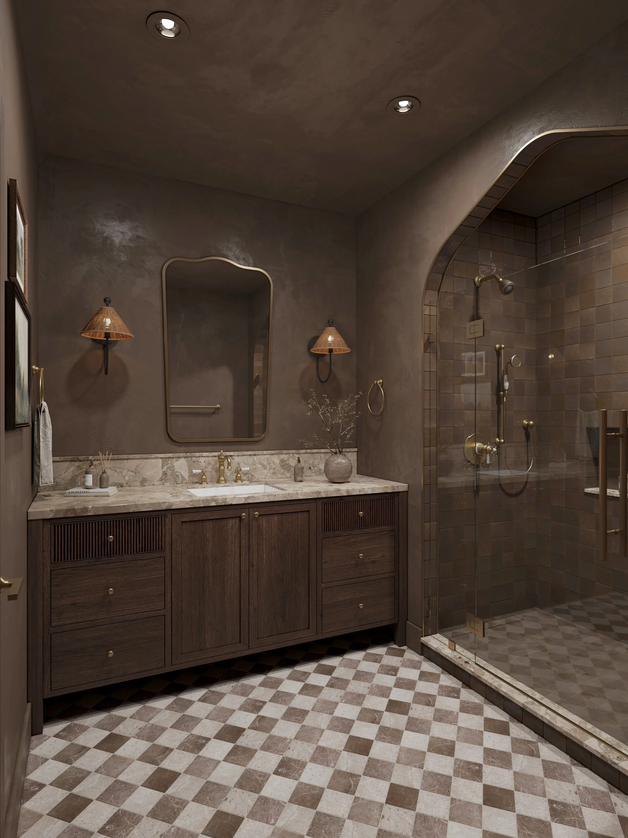 A bathroom with a wooden vanity, marble countertop, and a mirror above it. The wall and ceiling are painted in earthy tones, with wall-mounted light fixtures. There is a glass shower with dark tiles and gold fixtures on the right, and a checkered sto