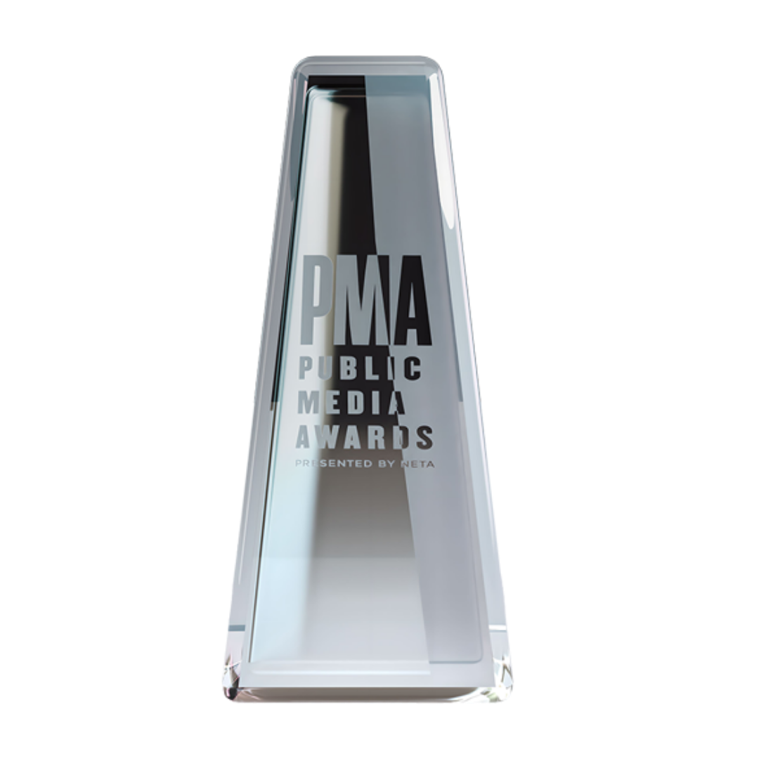 Glass award trophy with the text 'PMA Public Media Awards Presented by Meta' engraved on it.