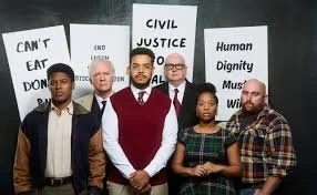 Group of five people standing in front of protest signs advocating for civil justice and human dignity.
