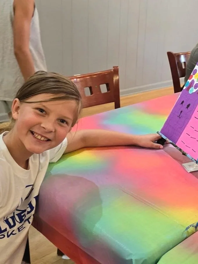 a girl showing off her canvas