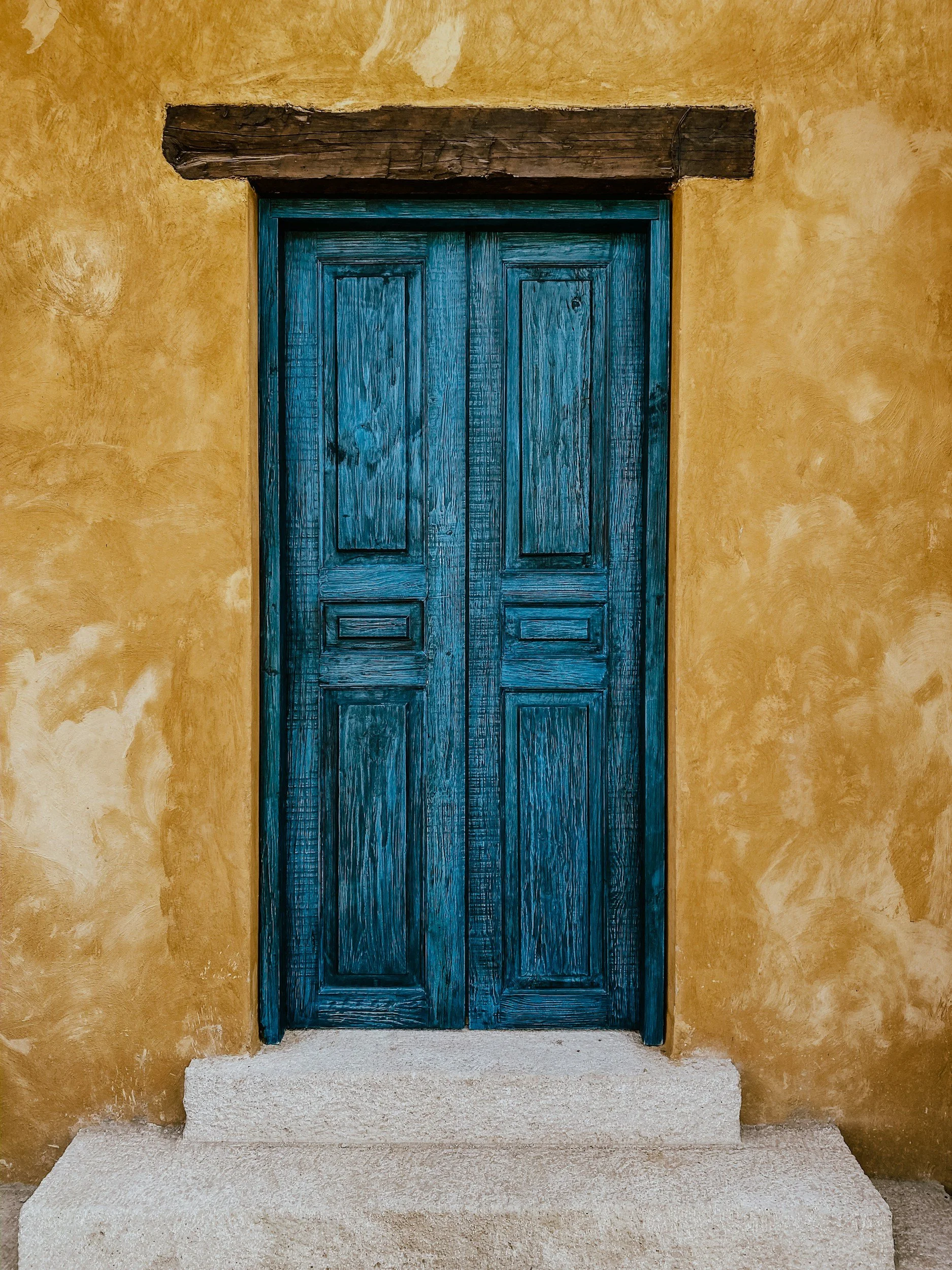 A blue and yellow door, symbolizing the start of a journey