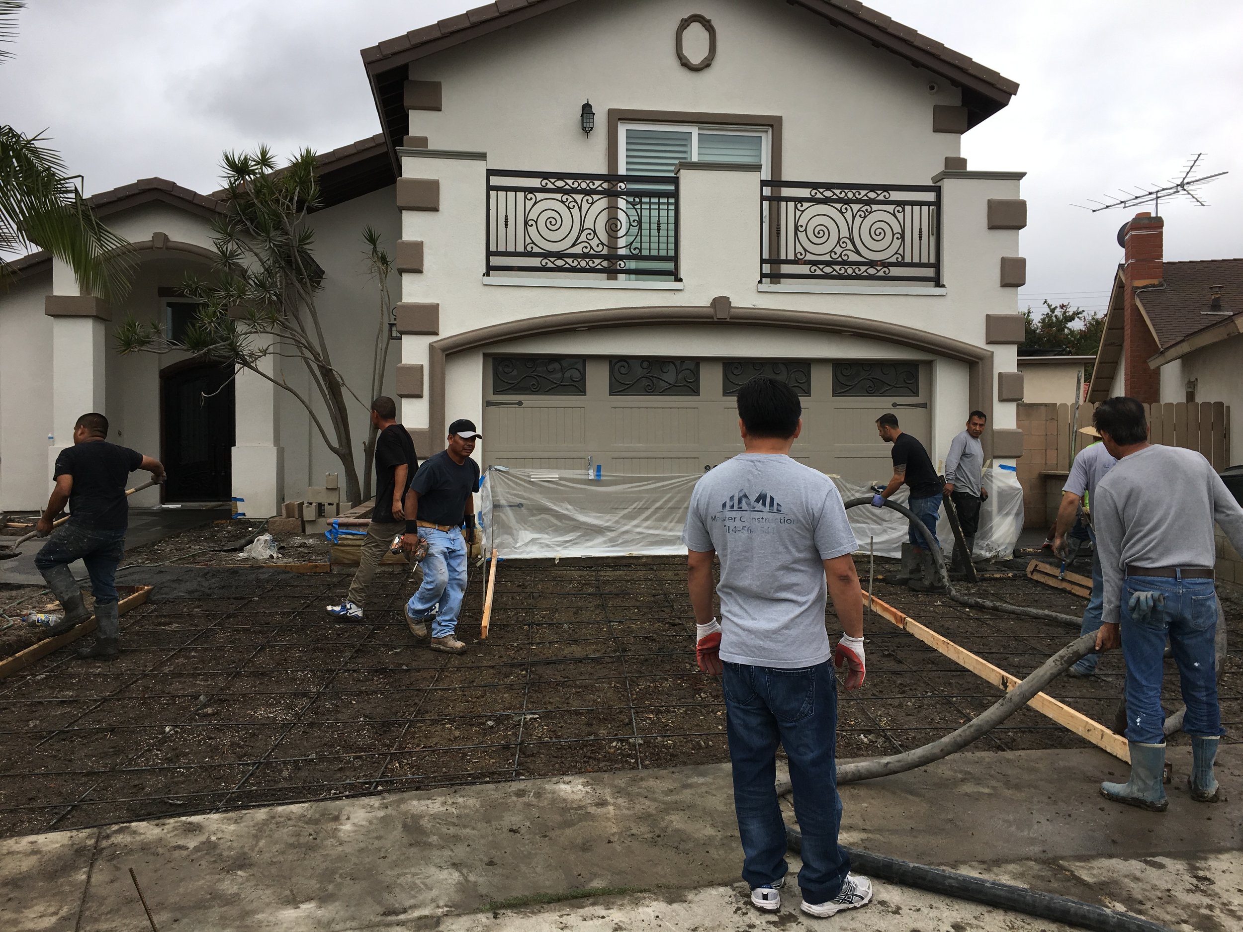Workers working on front of house.JPG
