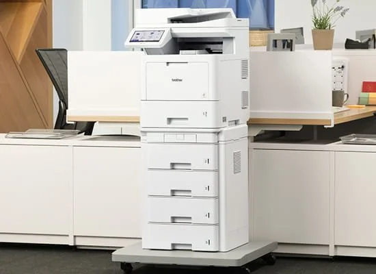 A white multifunction printer/copier in an office setting.