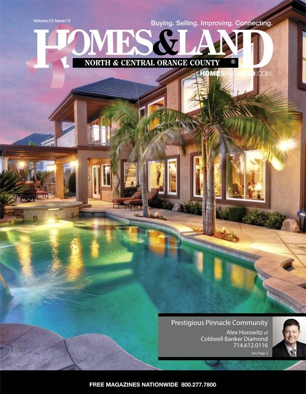 Cover of Homes & Land magazine featuring a luxurious backyard with a swimming pool, palm trees, and a modern house exterior during sunset.