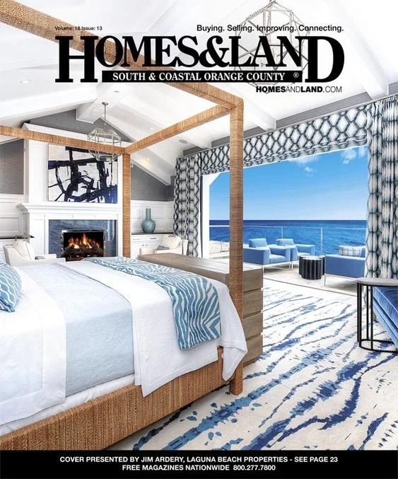 Magazine cover of Homes & Land featuring a luxurious beachfront bedroom with a view of the ocean, a four-poster bed, modern furniture, and a spacious balcony with outdoor seating.