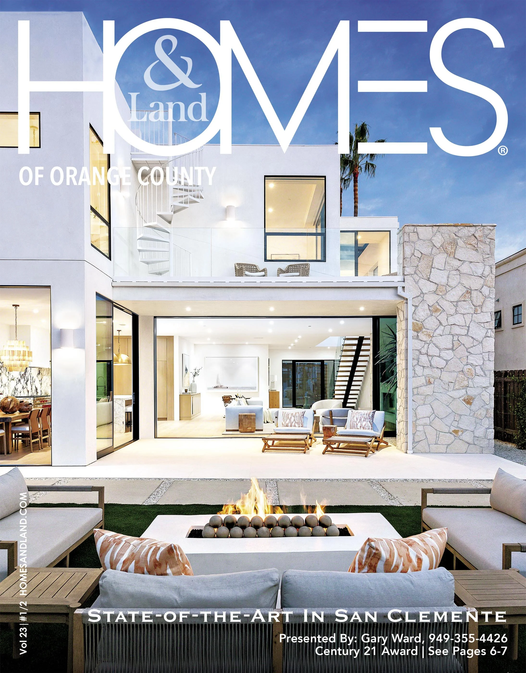 Modern white house with large glass sliding doors opening to an outdoor patio with seating, a fire feature, and a second-story balcony in Orange County showcased on Homes & Land magazine cover.