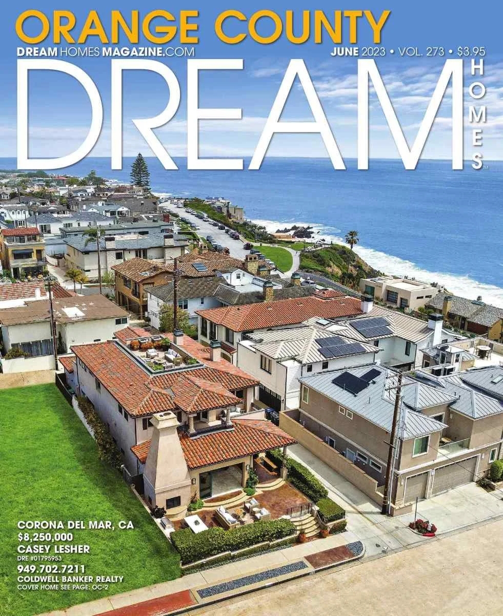 Aerial view of houses in Corona del Mar, California, with ocean in background, on the cover of Dream Homes Magazine June 2023 issue.