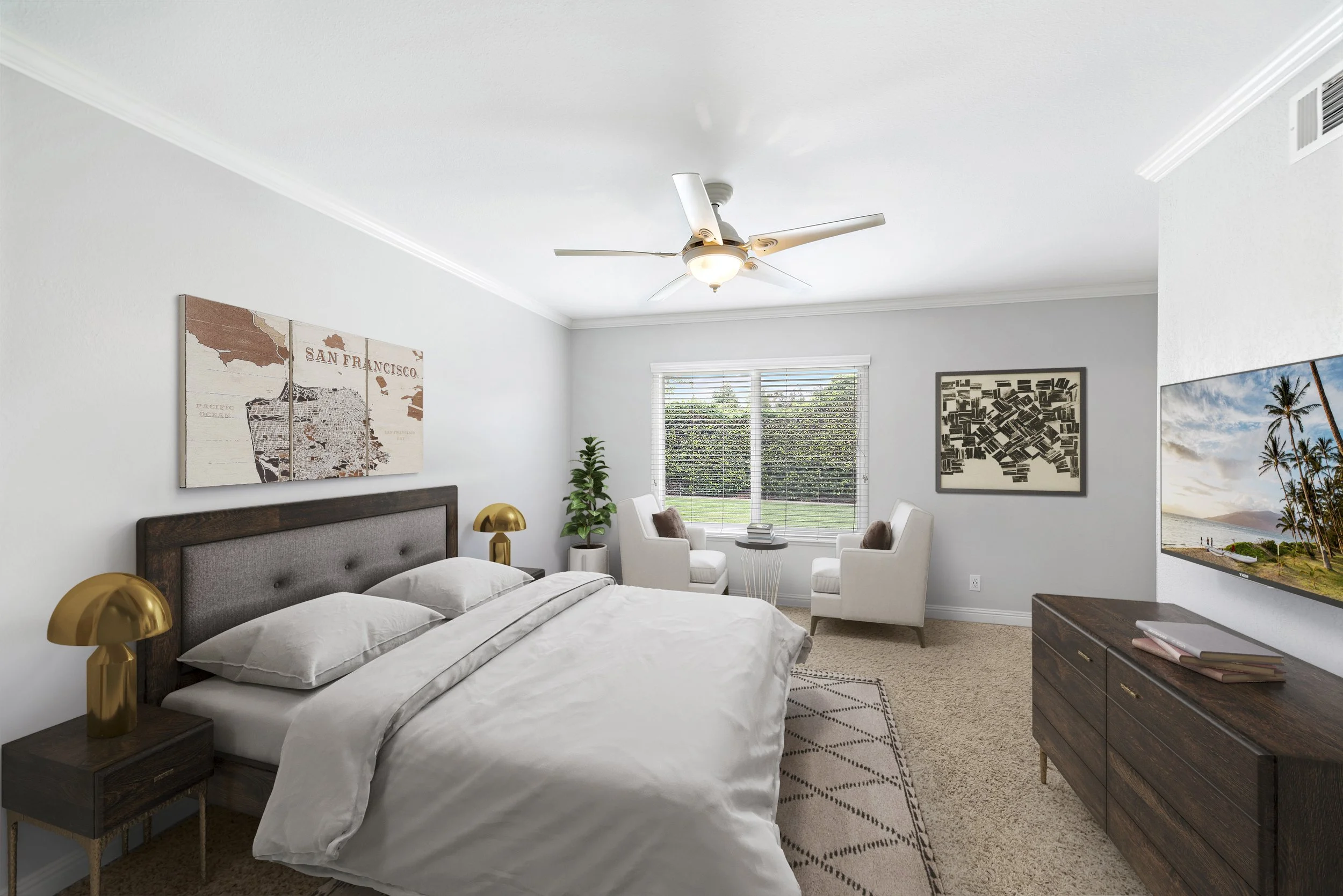 Modern bedroom with white walls, a large bed with a wooden headboard, two gold bedside lamps, a window with blinds, two white armchairs near the window, wall art including a map of San Francisco and an abstract black and white piece, a flat-screen TV