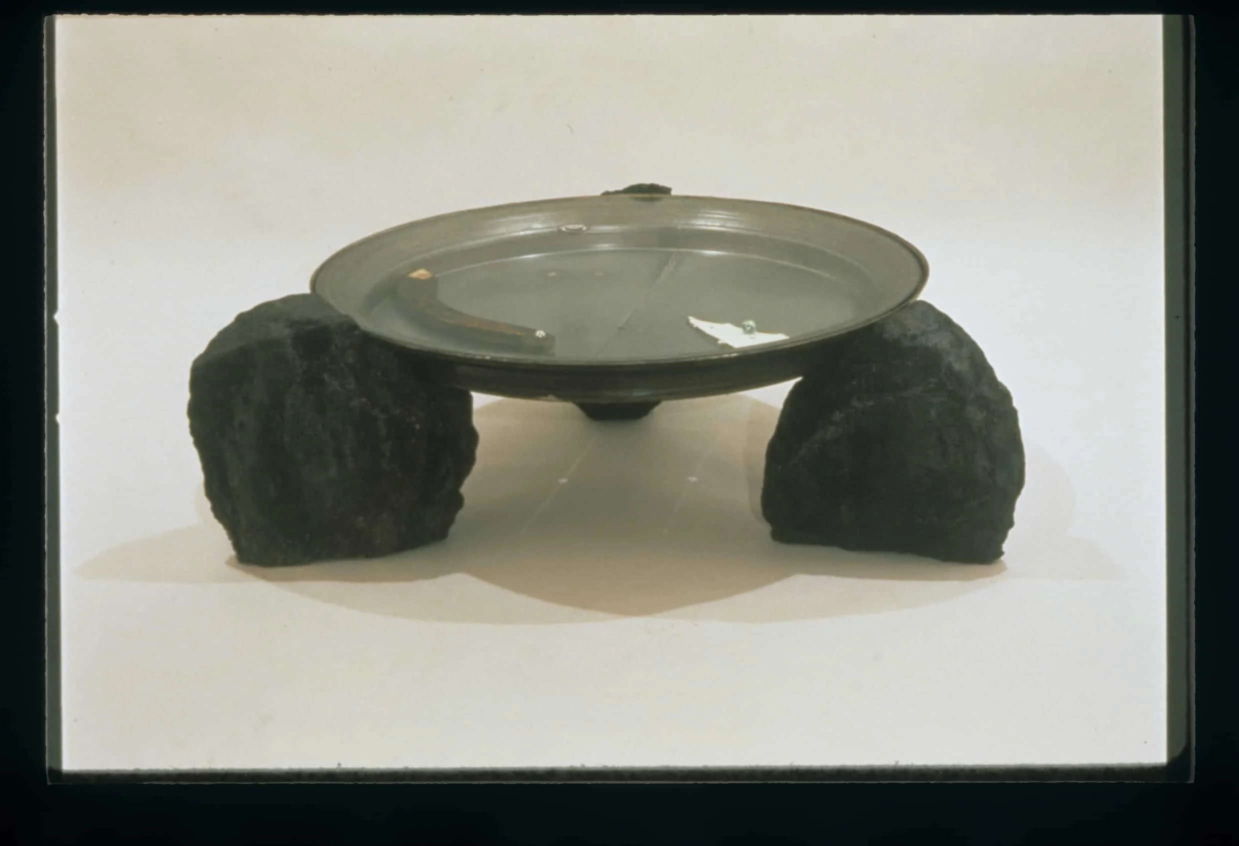 "Clock/Rock" 1991, Bronze, Steel, Glass, Wood, Paper, Stone, 15"H x 46"W x 46"D