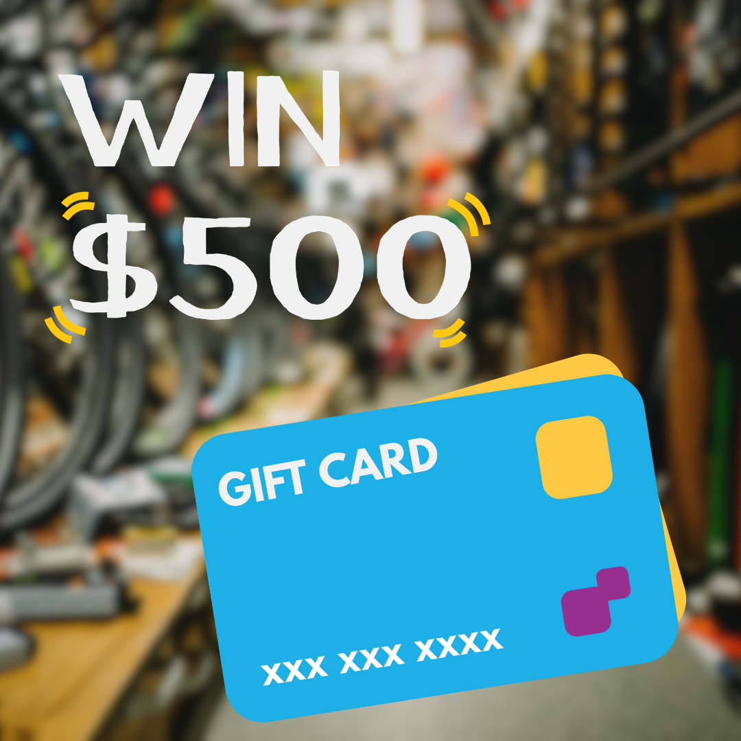 Promotional graphic with bold white text reading "Win $500" over a blurred bike shop background, with an illustrated blue and yellow gift card in the foreground.