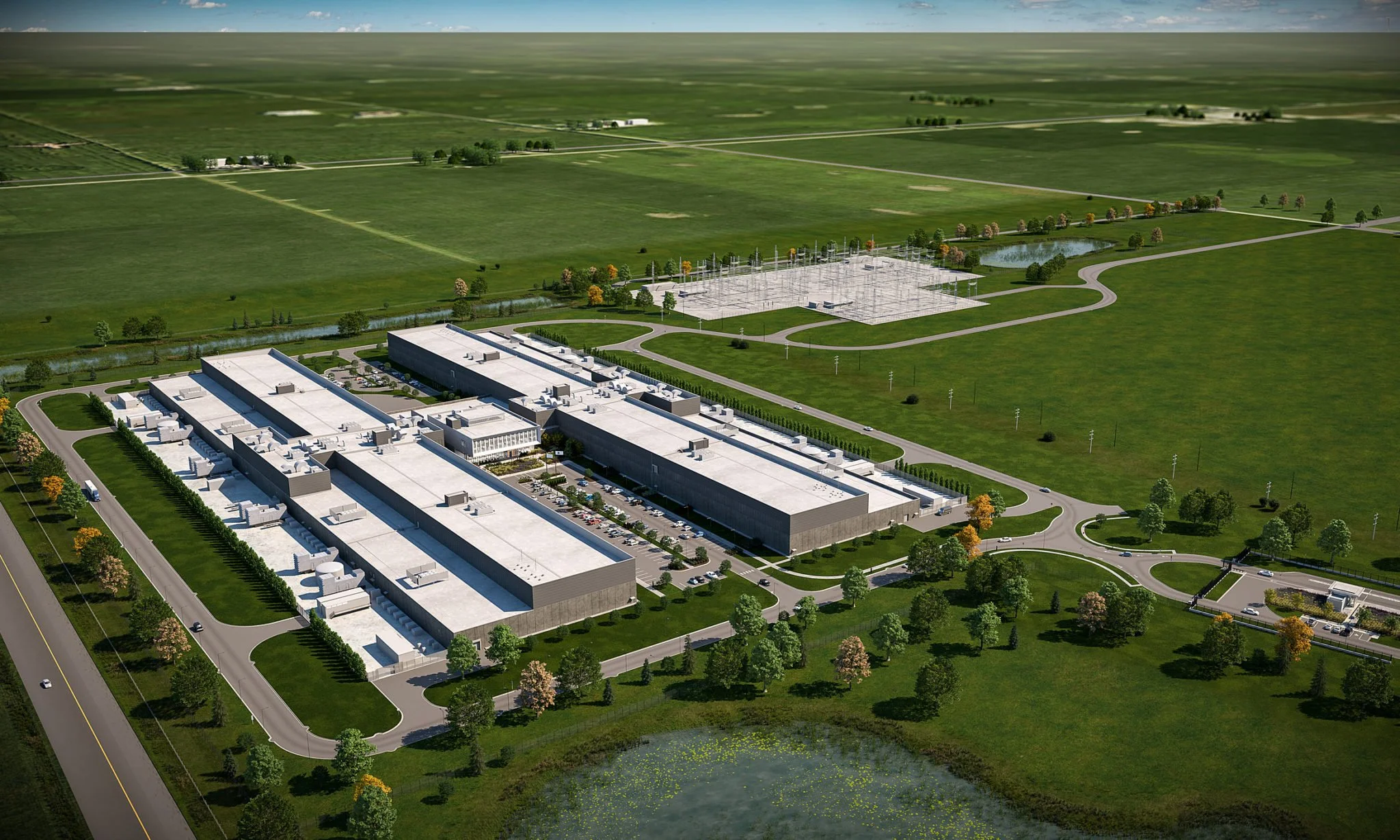 Aerial view of a large modern industrial facility with multiple buildings, parking lots, and surrounding greenery, including a pond and open fields.