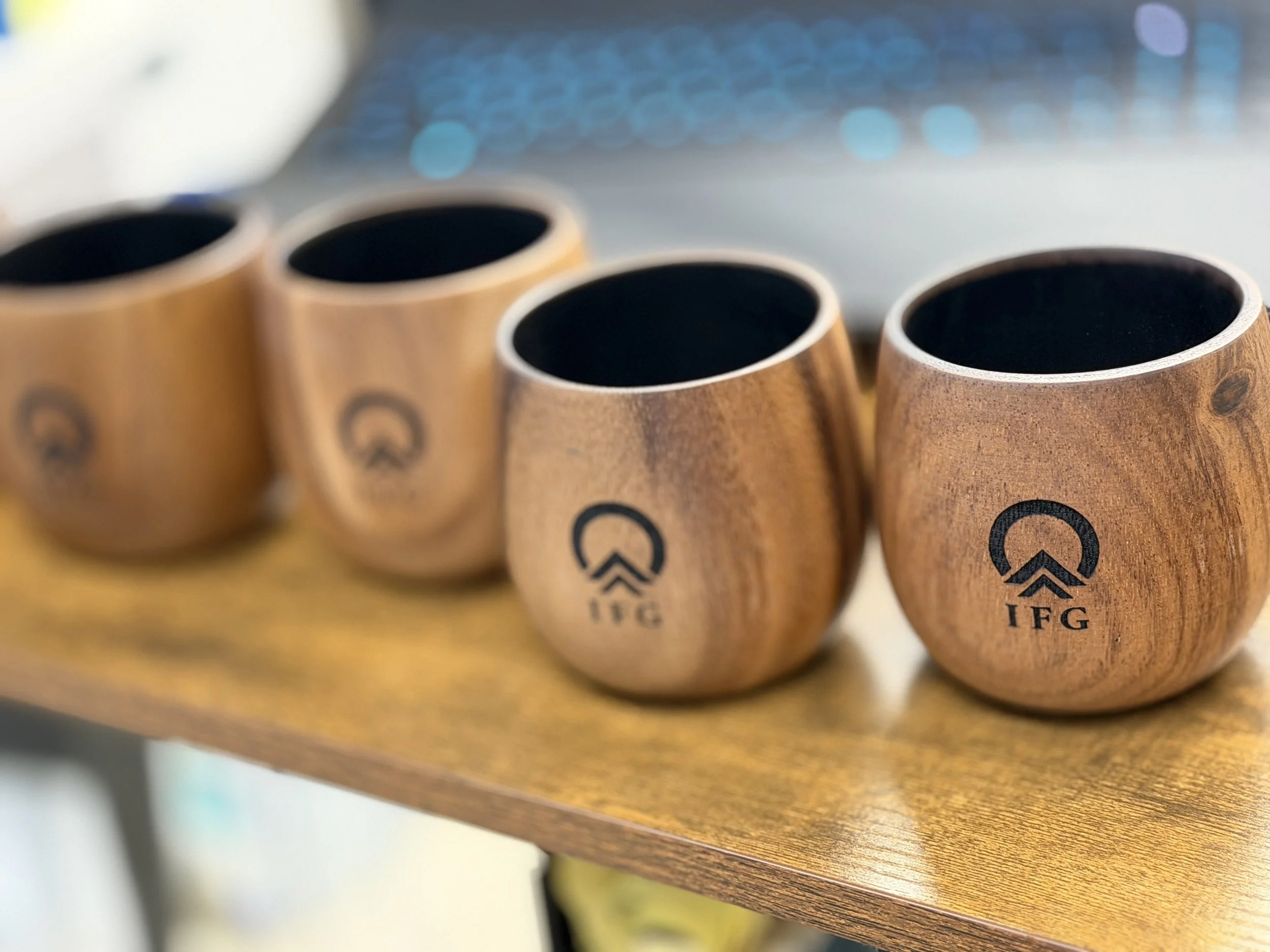 Four wooden cups with black interiors and the 