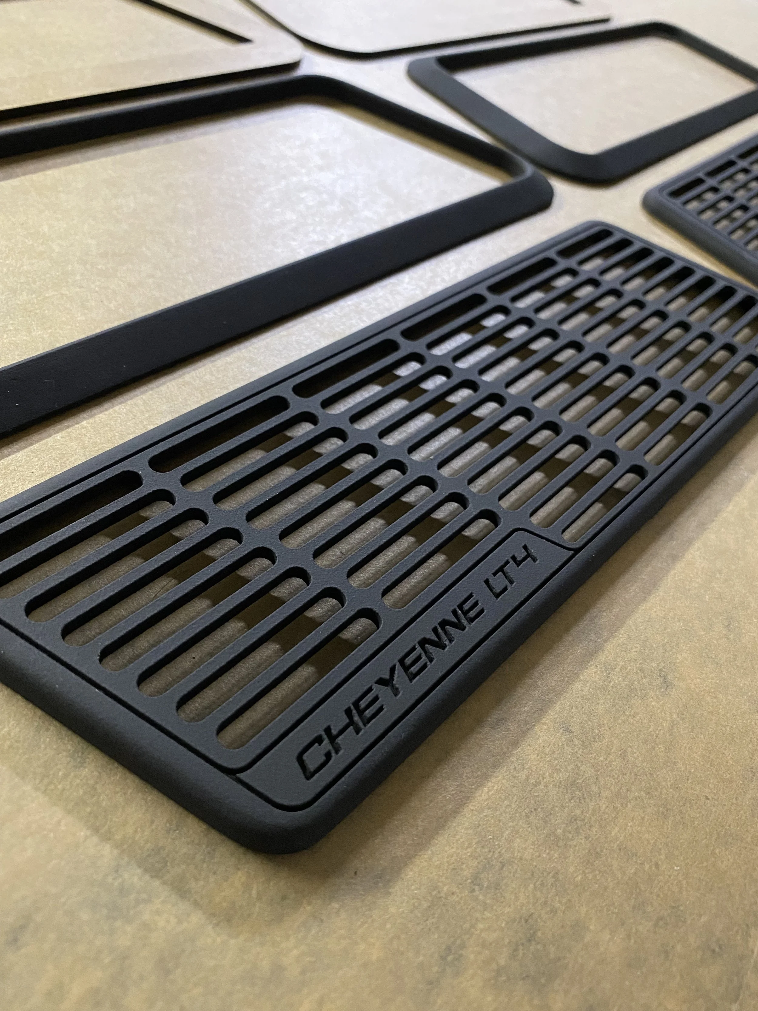 Various black rubber kitchen mats and mats for outdoor use on a beige surface.