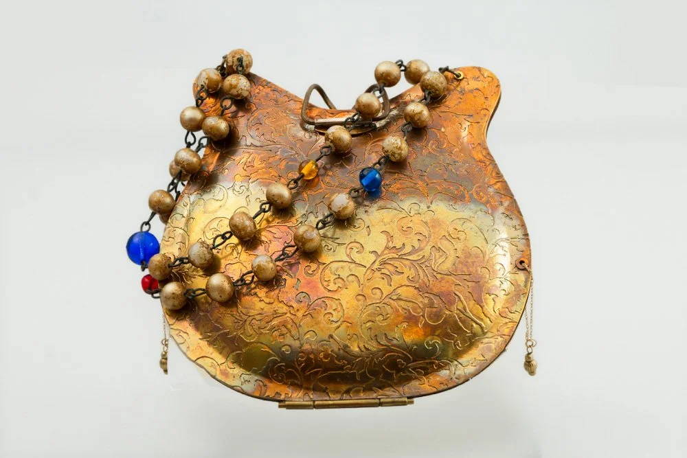 Hold the Memories (Etched brass, gold, glass beads, synthetic sapphire stone.  5" x 4")