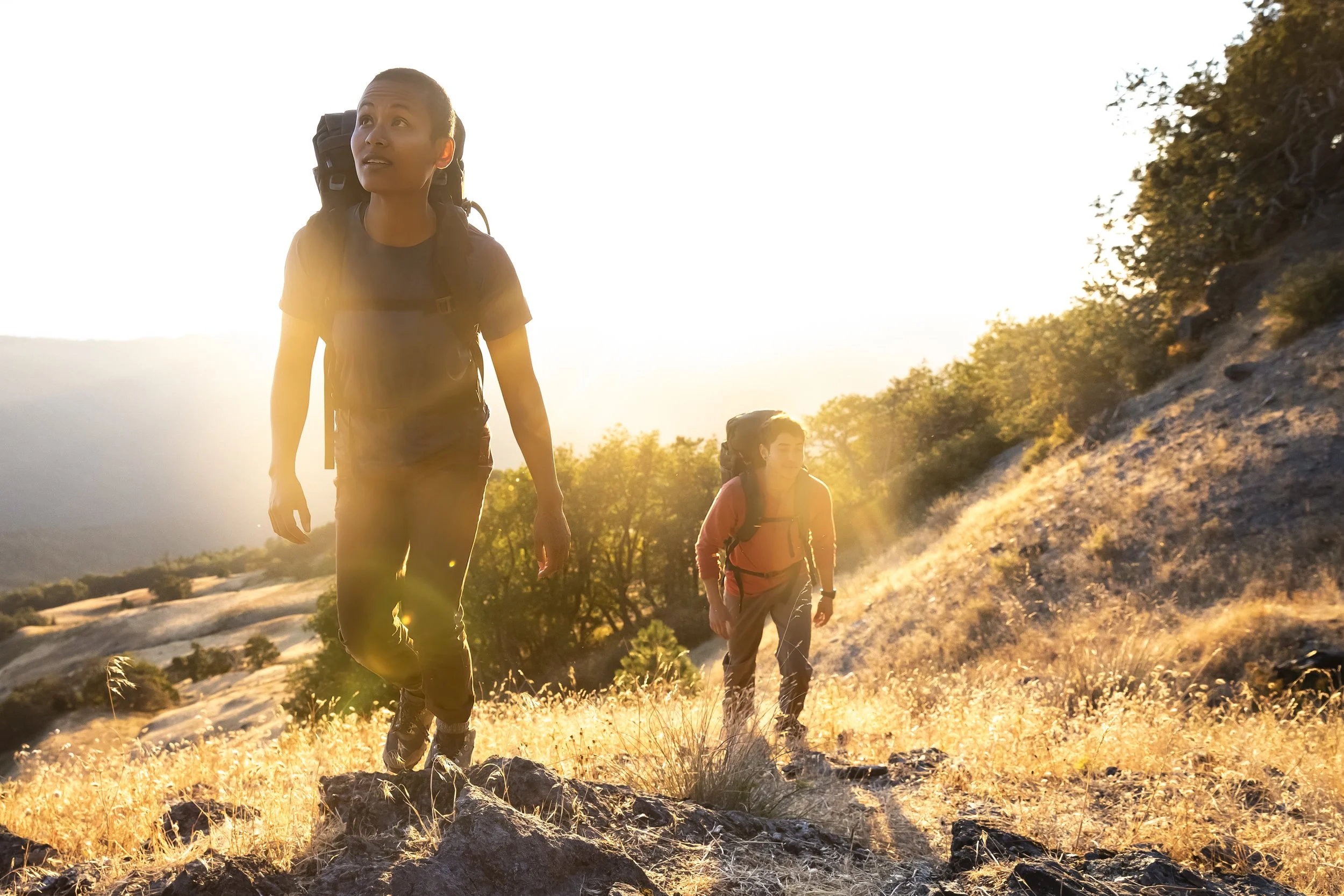 Backpackers exploring in Humboldt County at sunset with golden light during an Osprey lifestyle shoot, photographed by Fieldborn Creative.