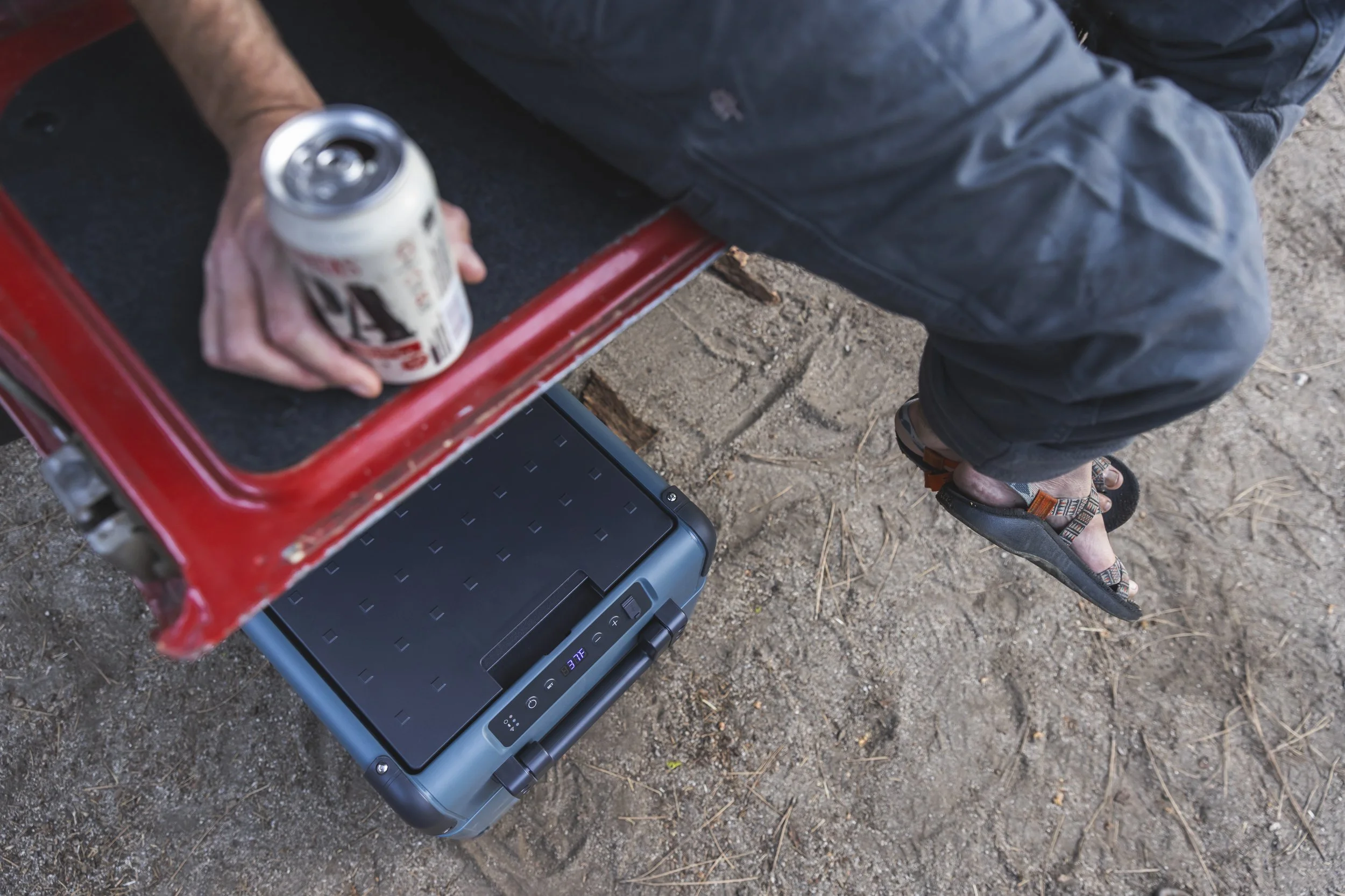 Person sitting on a tailgate with a Lagunitas beer and Dometic cooler nearby during an outdoor lifestyle shoot in Northern California, photographed by Fieldborn Creative.