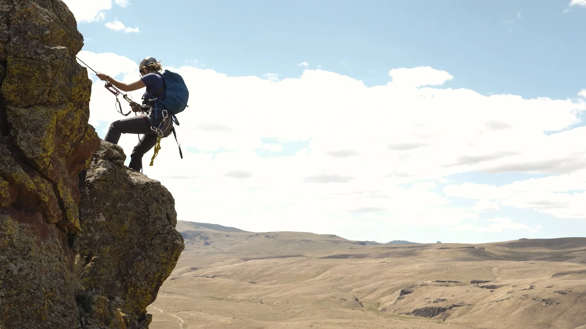 Caitlin Davis rappelling into a raptor nest in Idaho’s sagebrush country for the Golden film, photographed by Fieldborn Creative.
