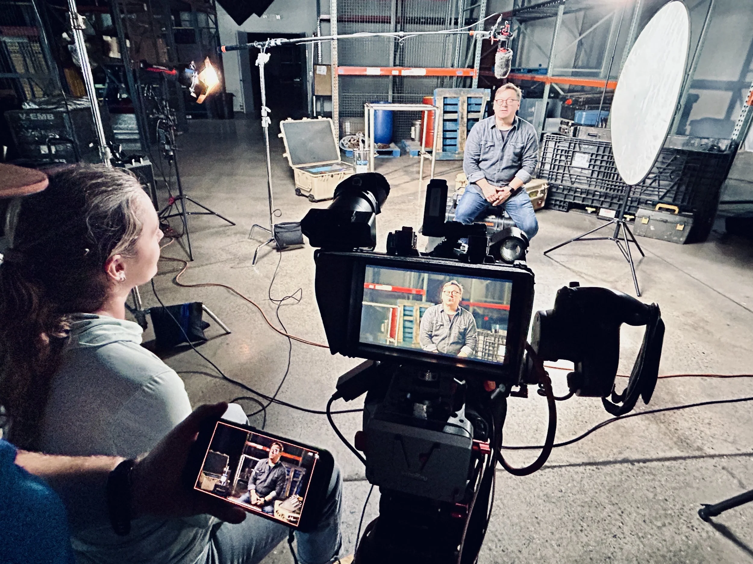 Behind-the-scenes photo of a production setup with an interview camera on location, photographed by Fieldborn Creative.