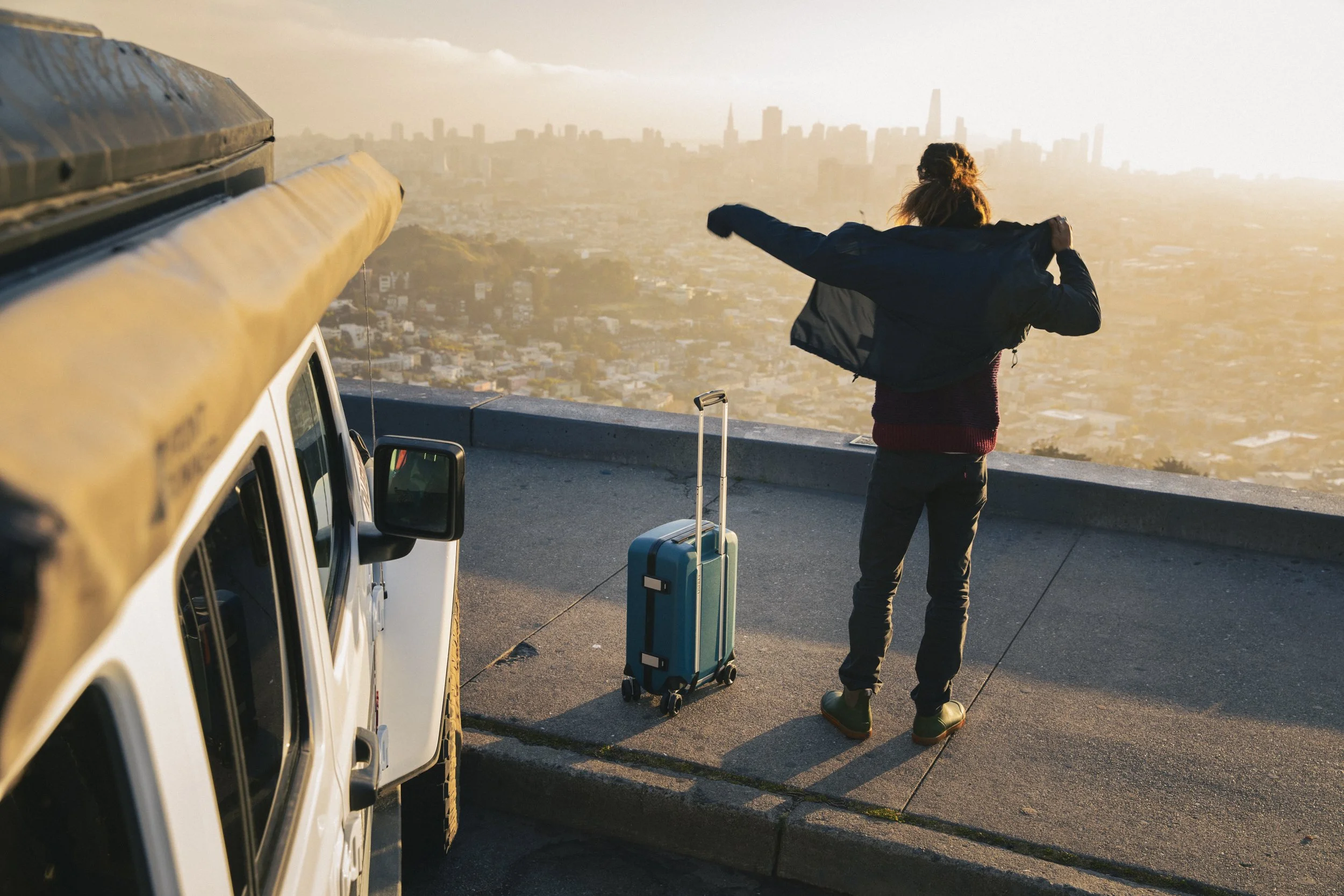 man in a San Francisco urban landscape with luggage, captured during an Osprey lifestyle assignment by Fieldborn Creative.
