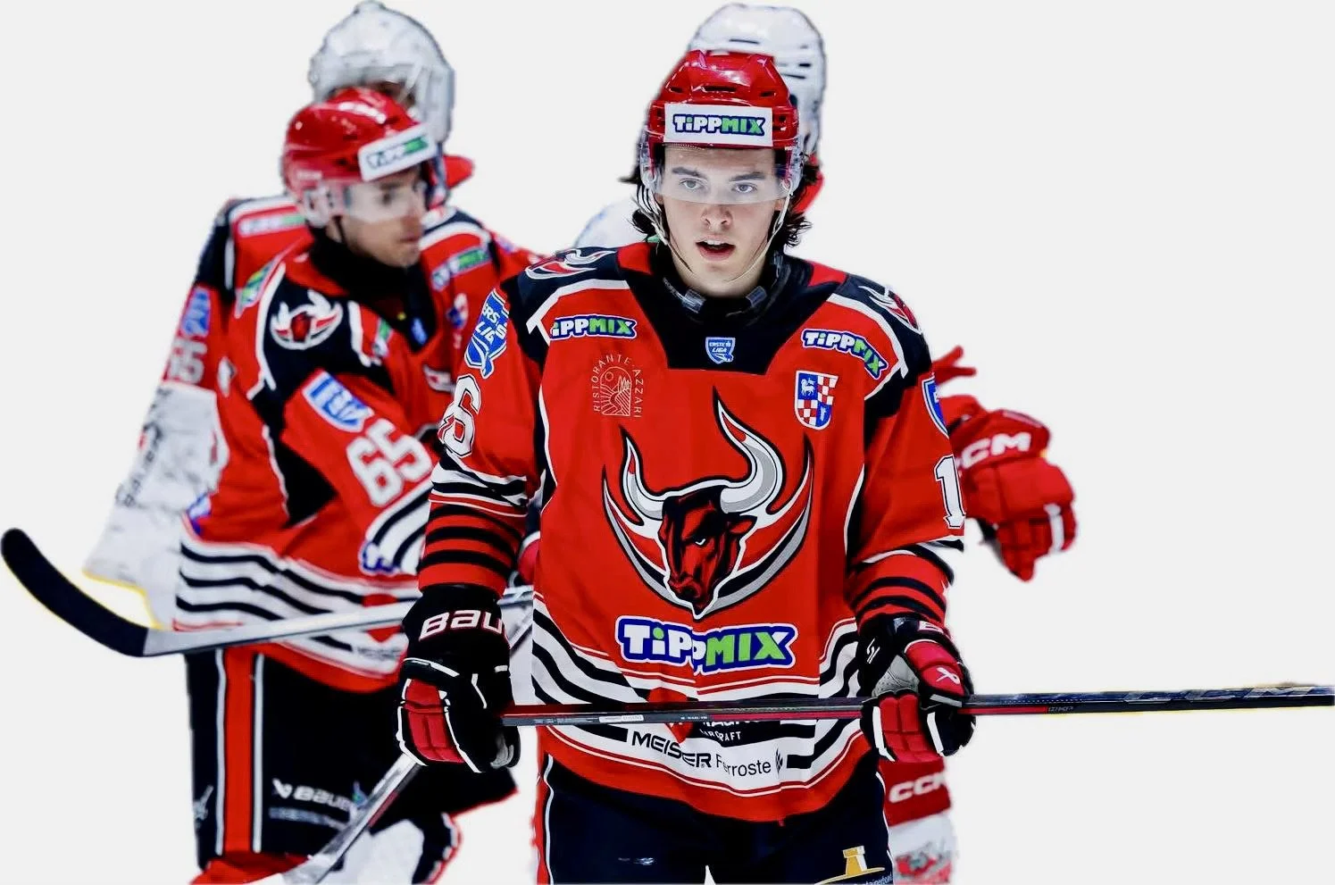 Ice hockey players in red jerseys with a bull logo, wearing helmets, on ice rink during a game.