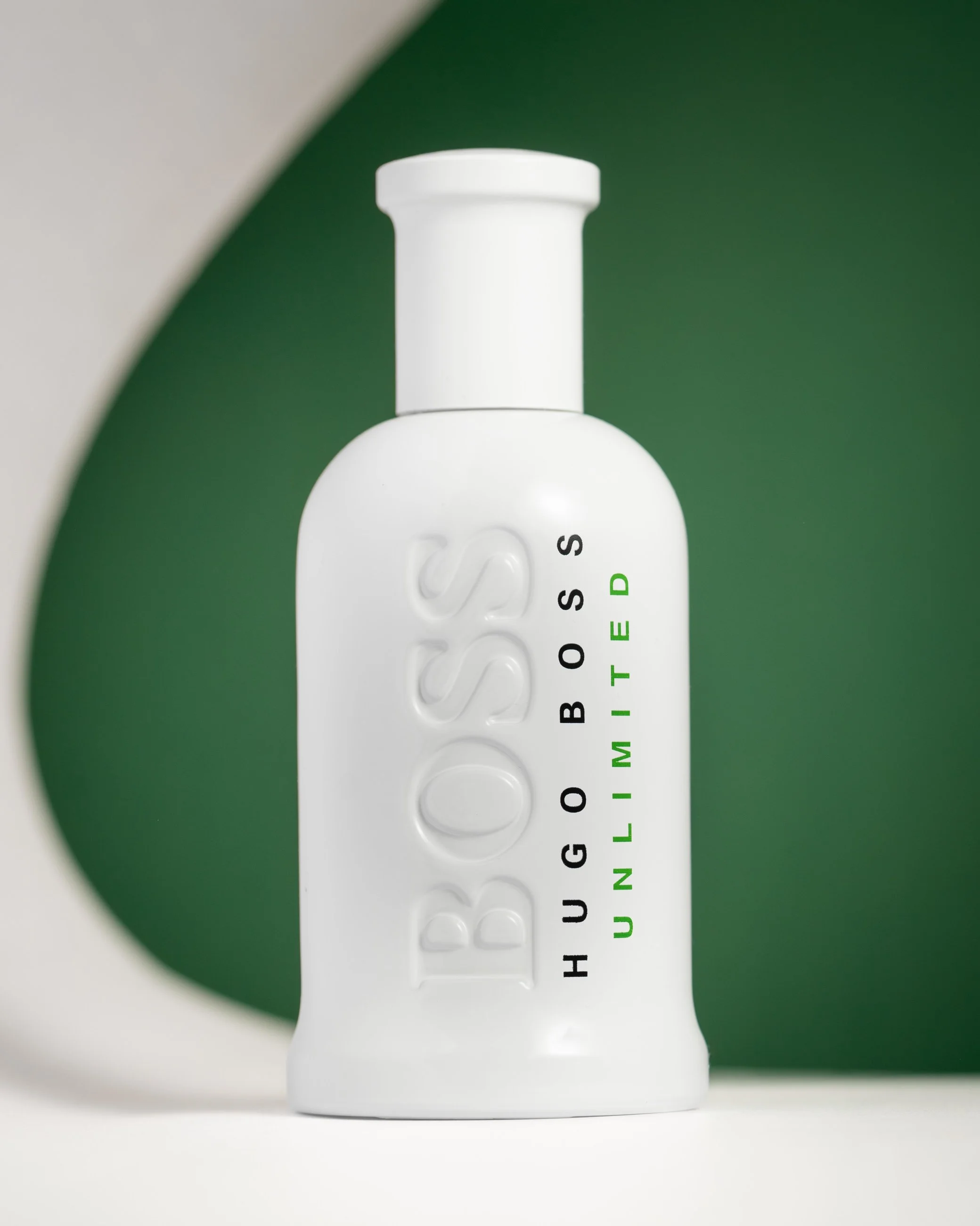 Hugo Boss perfume bottle product photography with minimal white and green background