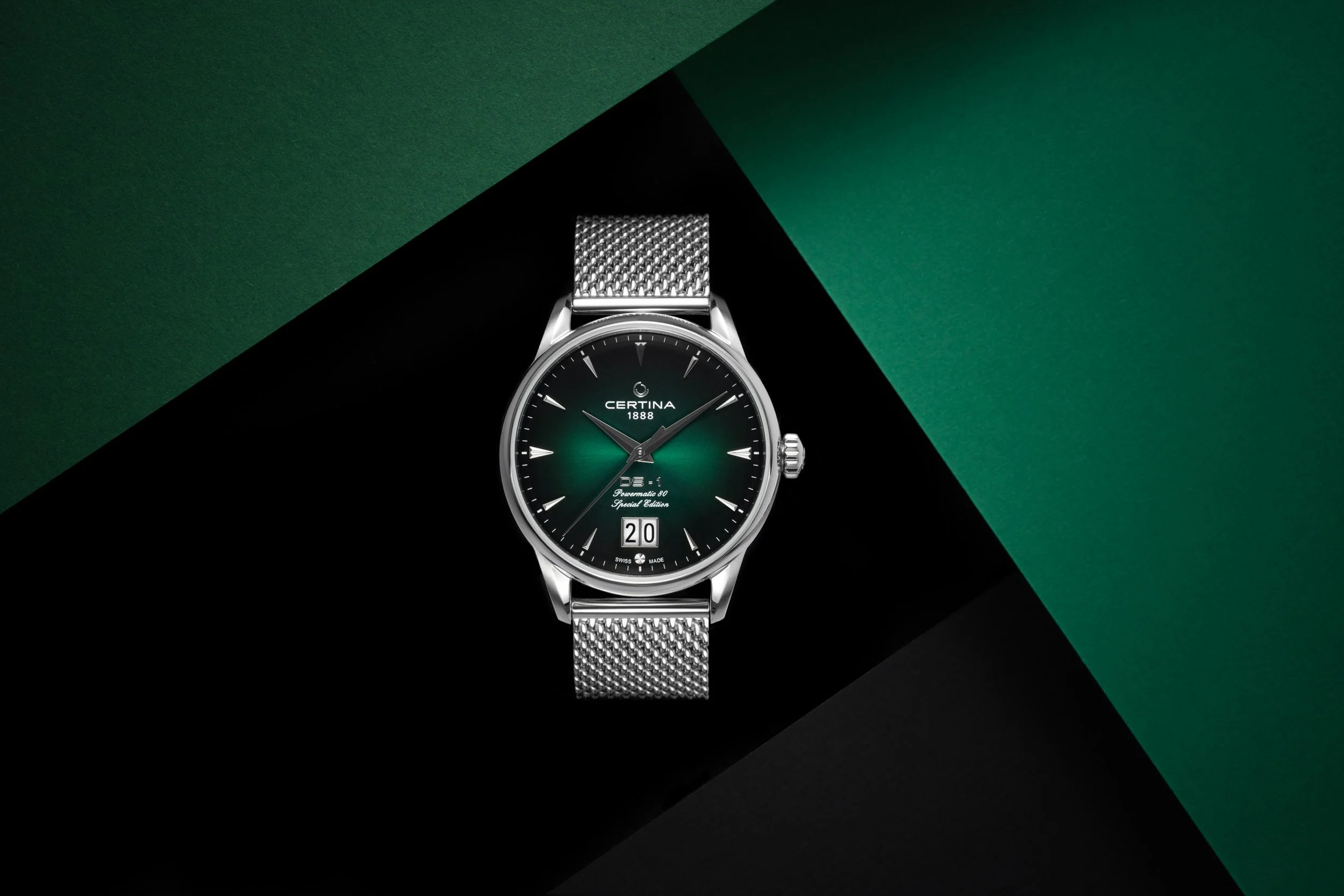 Luxury wristwatch product photography with green geometric lighting and dark background