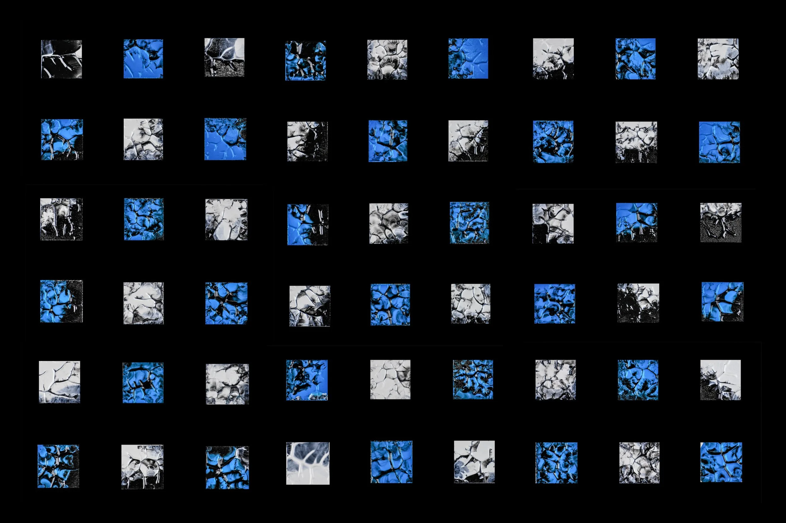 Abstract digital artwork with a grid of small squares featuring black, white, and blue cracked patterns on a black background.