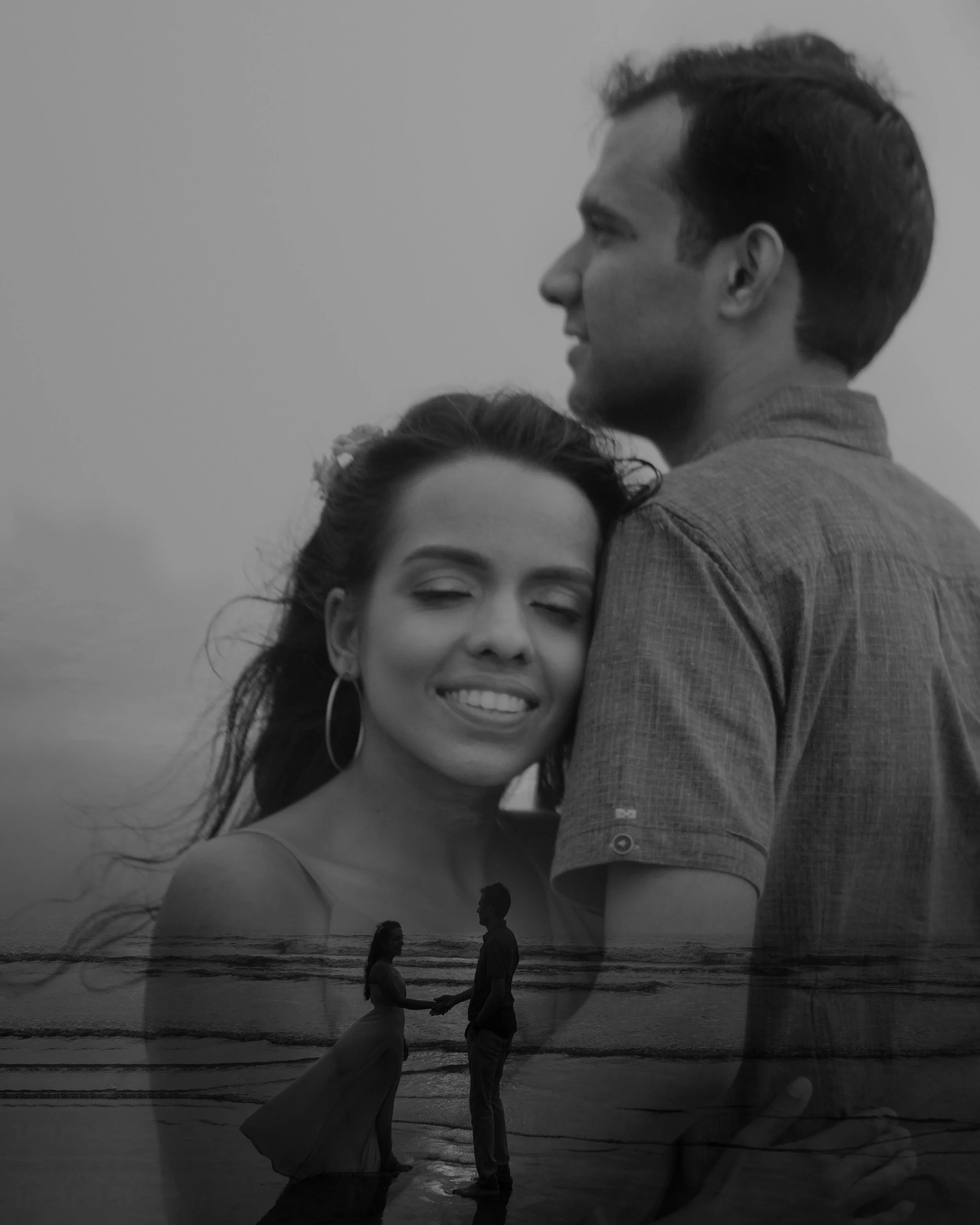 A double exposure photograph showing a smiling woman with her eyes closed and a man looking into the distance, with a scene of a couple holding hands at the beach overlaying their images.