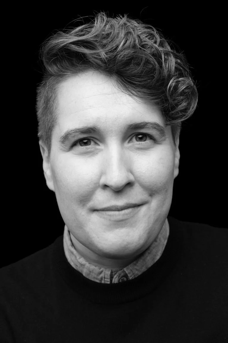 Black and white of Aileen Keown Vaux on a dark background.