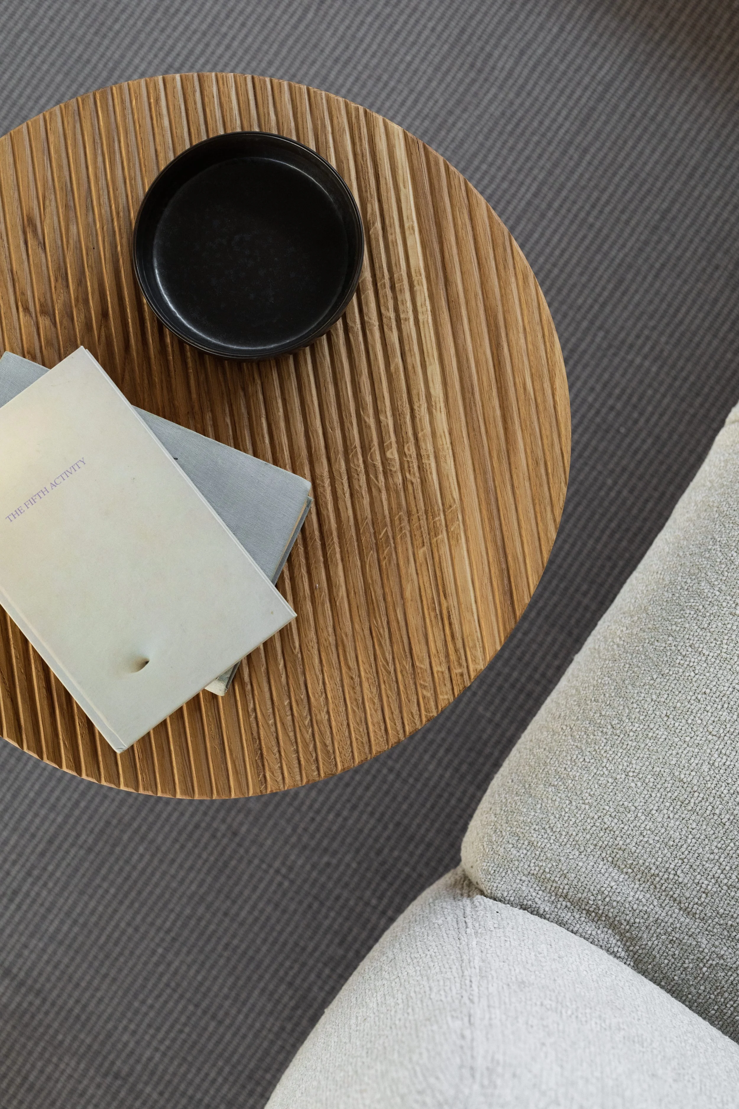kaboompics_wooden-fluted-table-books-light-beige-sofa-oak-boucle-25040.jpg